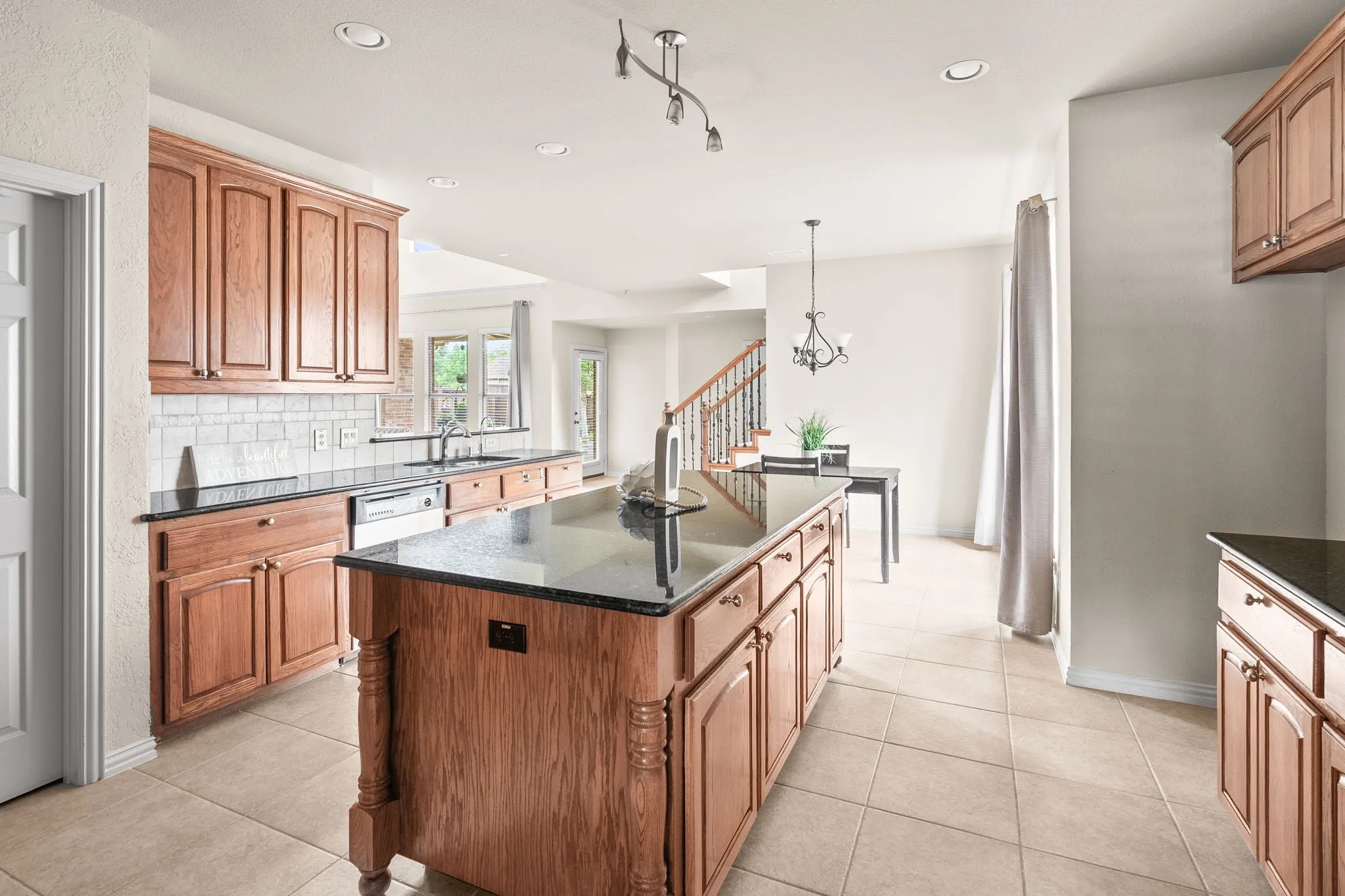 A chef's kitchen with massive island, walk in pantry and casual dining.