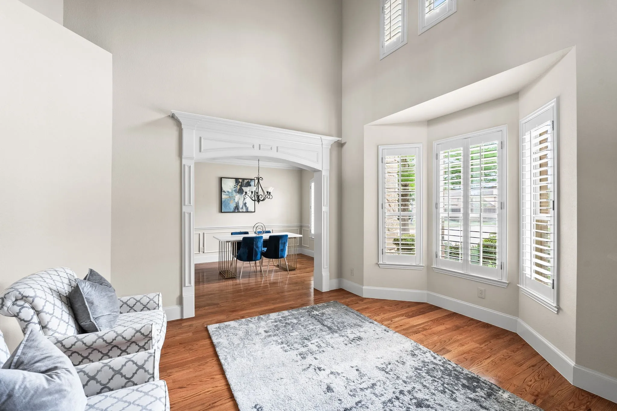 Beautiful formal iving room with tons of natural lights, plantation shutters and gorgeous​​‌​​​​‌​​‌‌​‌‌​​​‌‌​‌​‌​‌​​​‌​​ moldings.