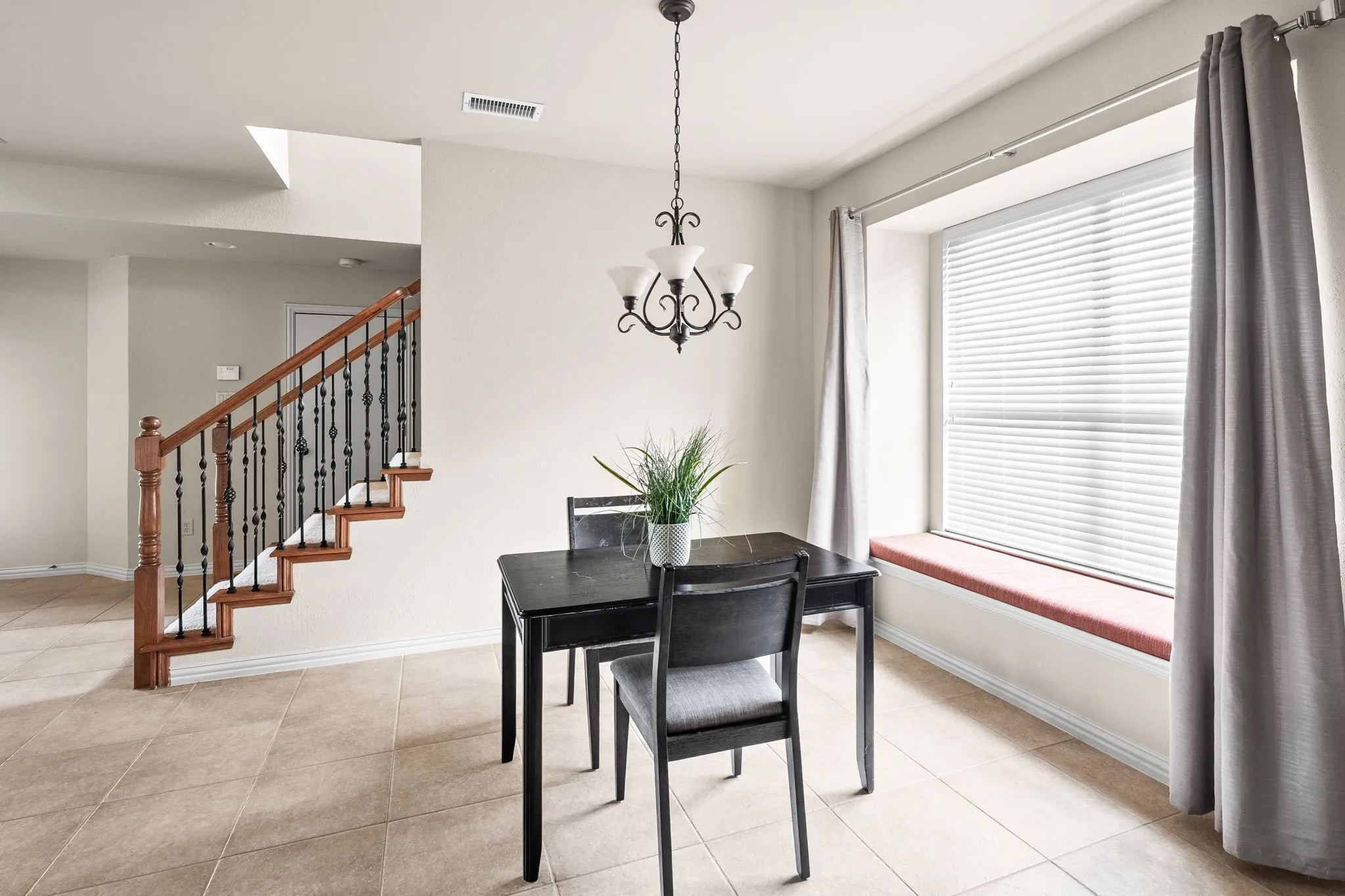 Casual diining in ktichen area with beautiful bench seat and natural light.