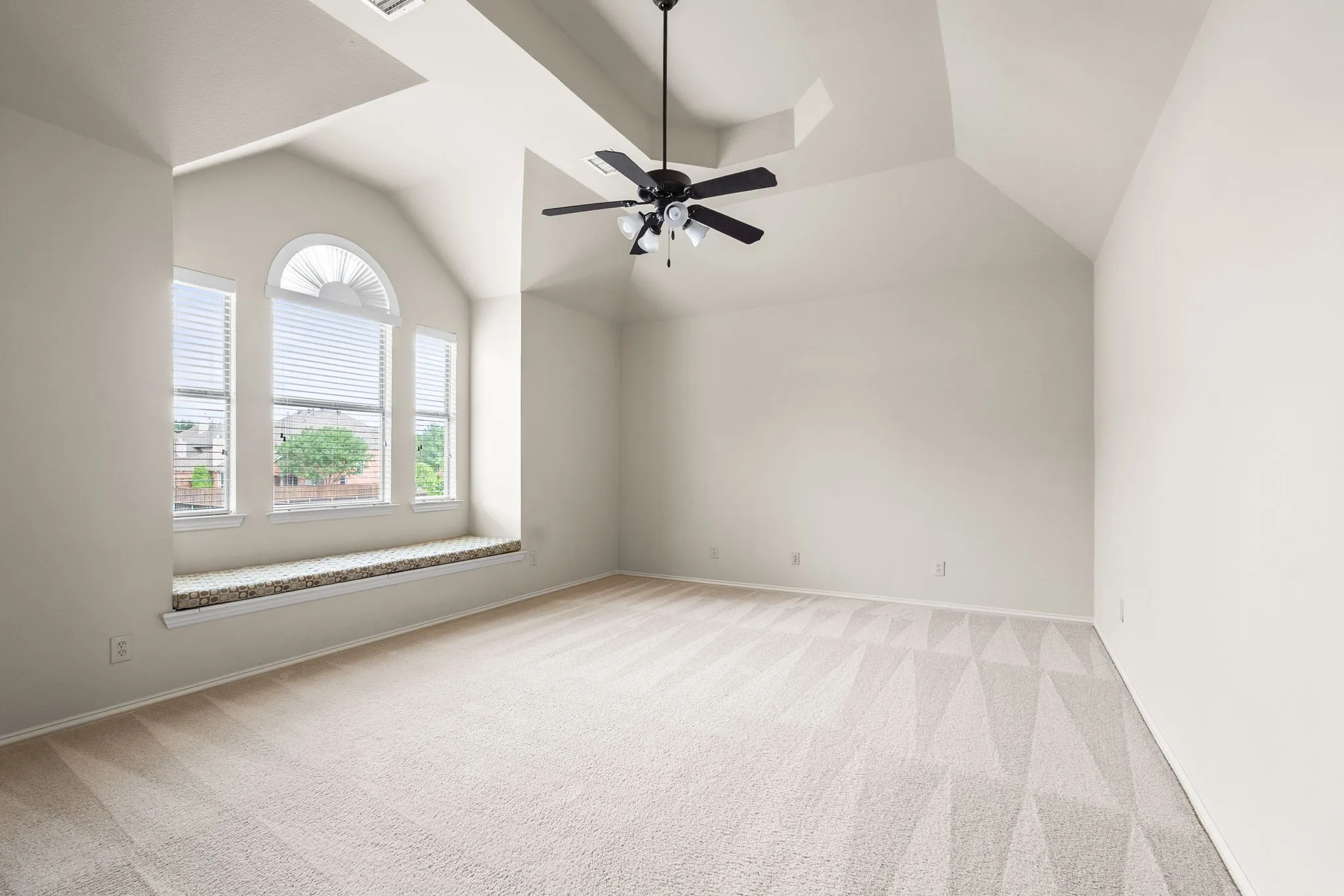 Large game room with bench seating for storage, tons of natural light and tray ceiling. (Note:Game room is over the garage so no concerns with potential noise)