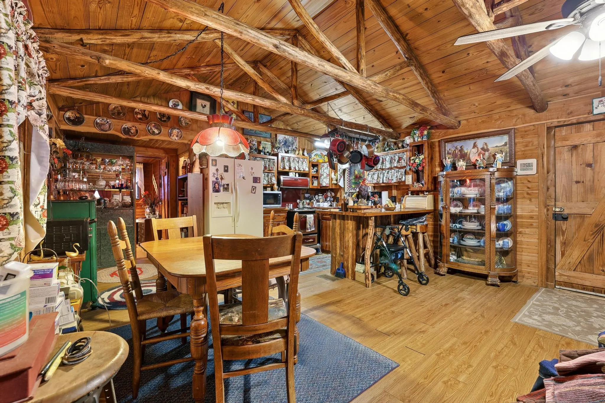 This property features a rustic interior with exposed wooden beams, wooden walls, and hardwood flooring