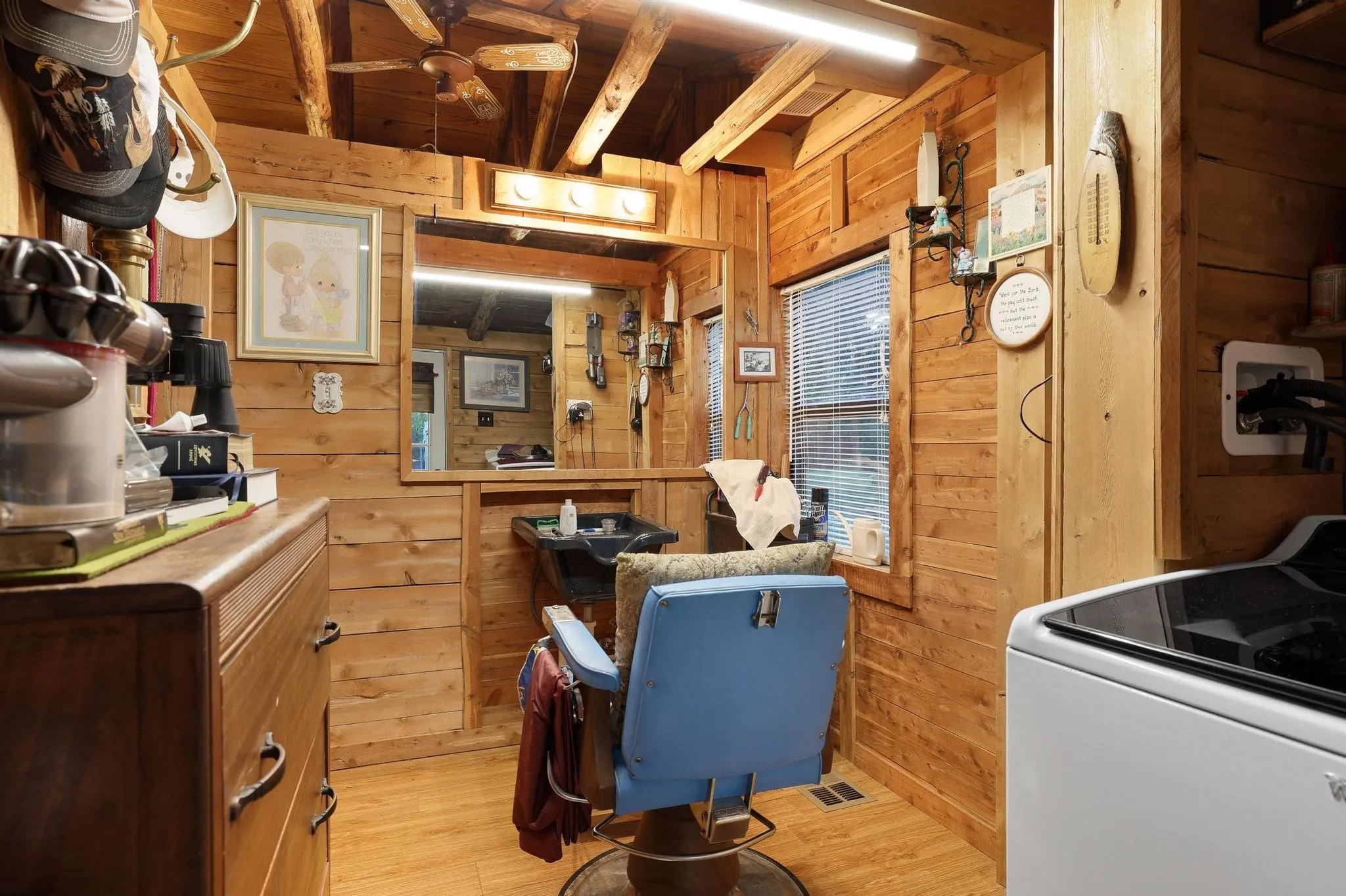 This space features extensive wood paneling throughout, exposed wooden ceiling beams, and hard flooring