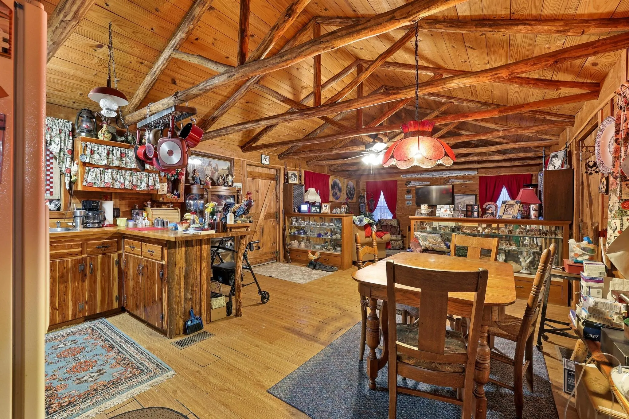 This property features an open-concept living area with wood plank ceilings, exposed wood beams, and wood flooring throughout