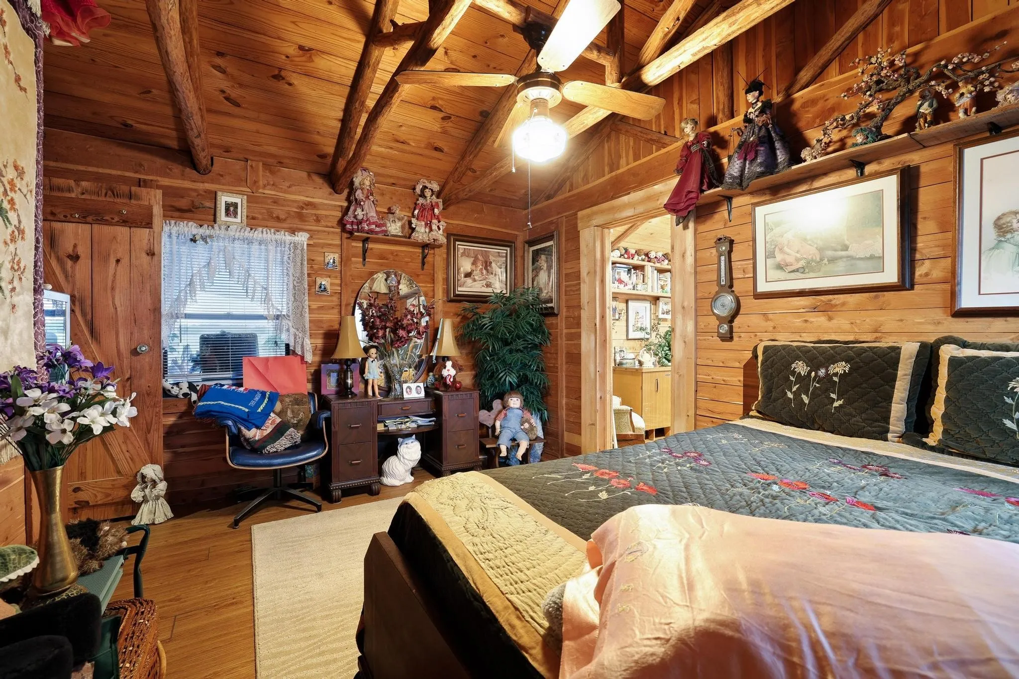 This property features extensive wood paneling throughout, including the walls and vaulted ceiling