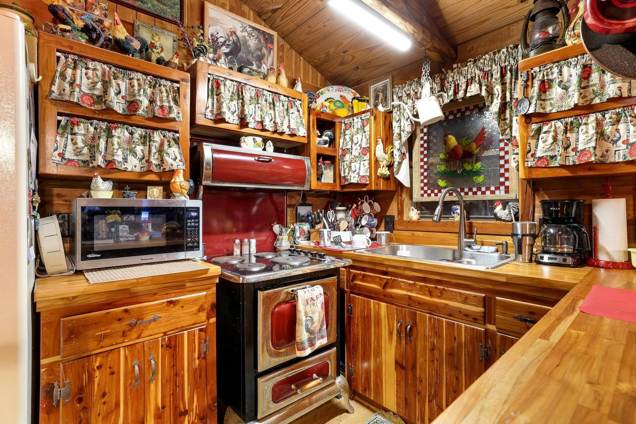 The kitchen features wood plank walls and ceilings, wood cabinetry, and wood countertops