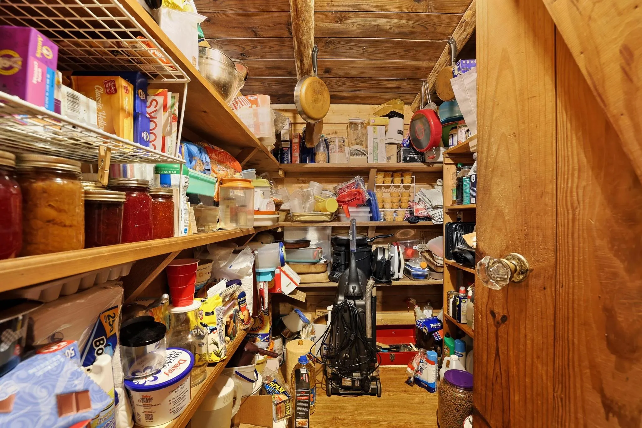 The property features a dedicated pantry with extensive wooden shelving