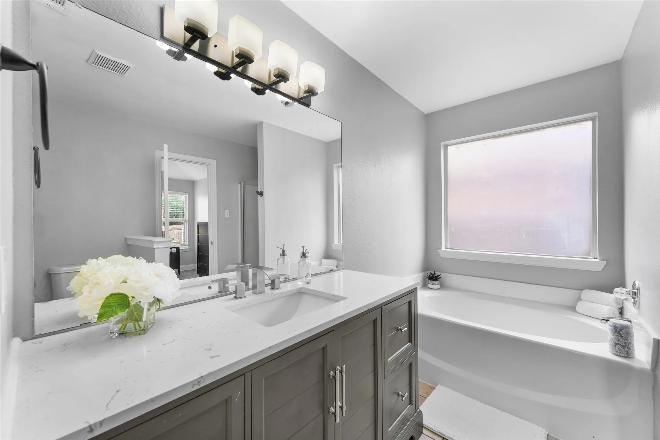 Bathroom featuring vanity and a bath