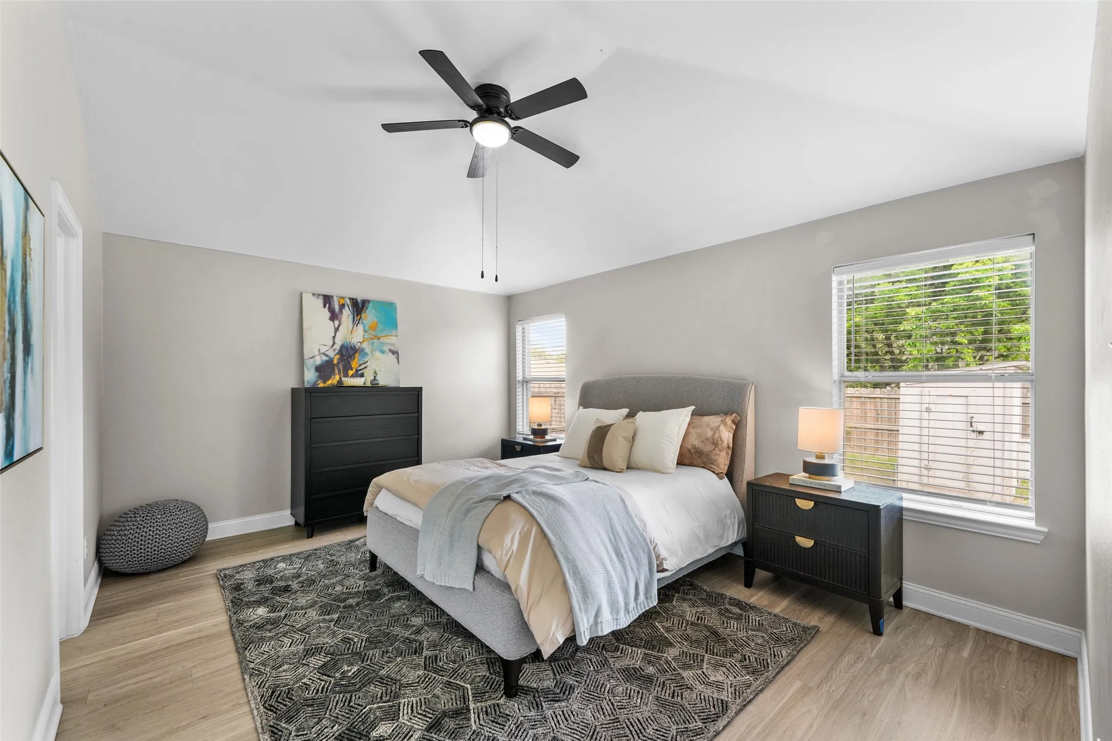 Bedroom featuring light wood-style floors, ceiling fan, and lofted ceiling