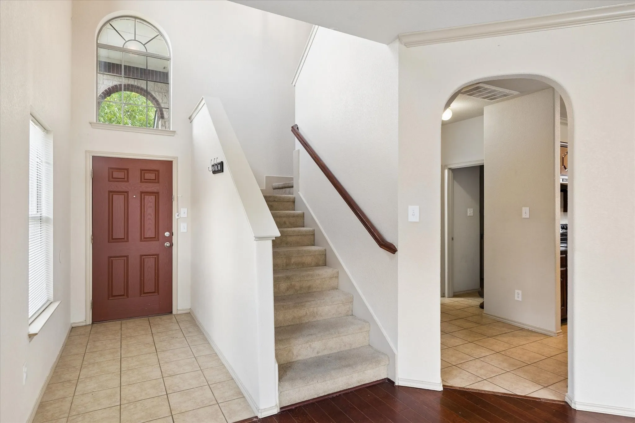 Entry into the home with stairs leading to the second floor with a second living area and the bedrooms.