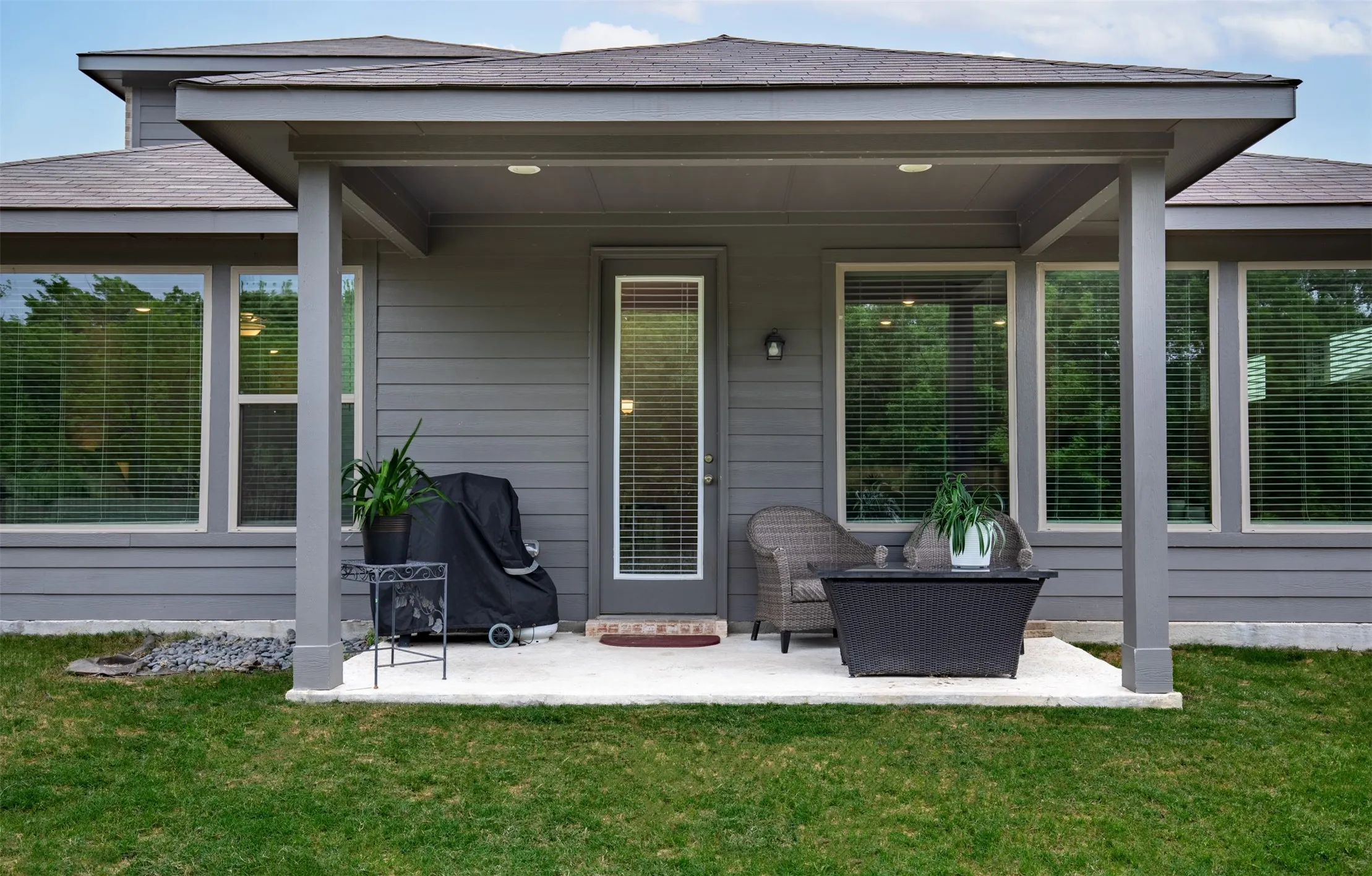 Covered patio overlooking green space.