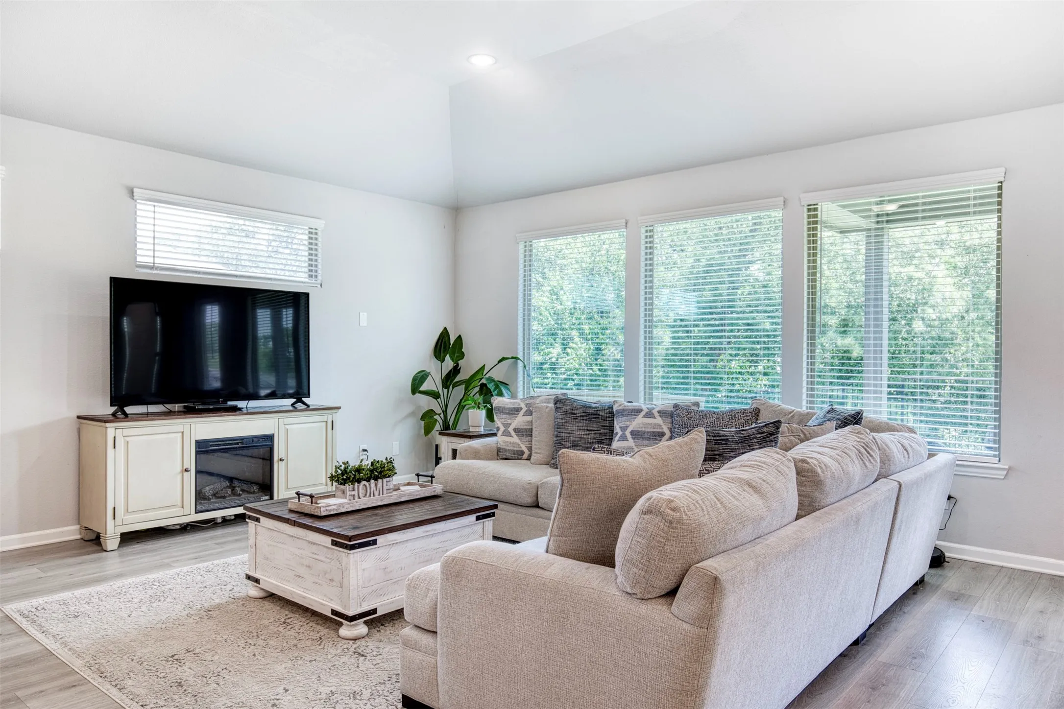 Living room with wall of windows overlooking the backyard.