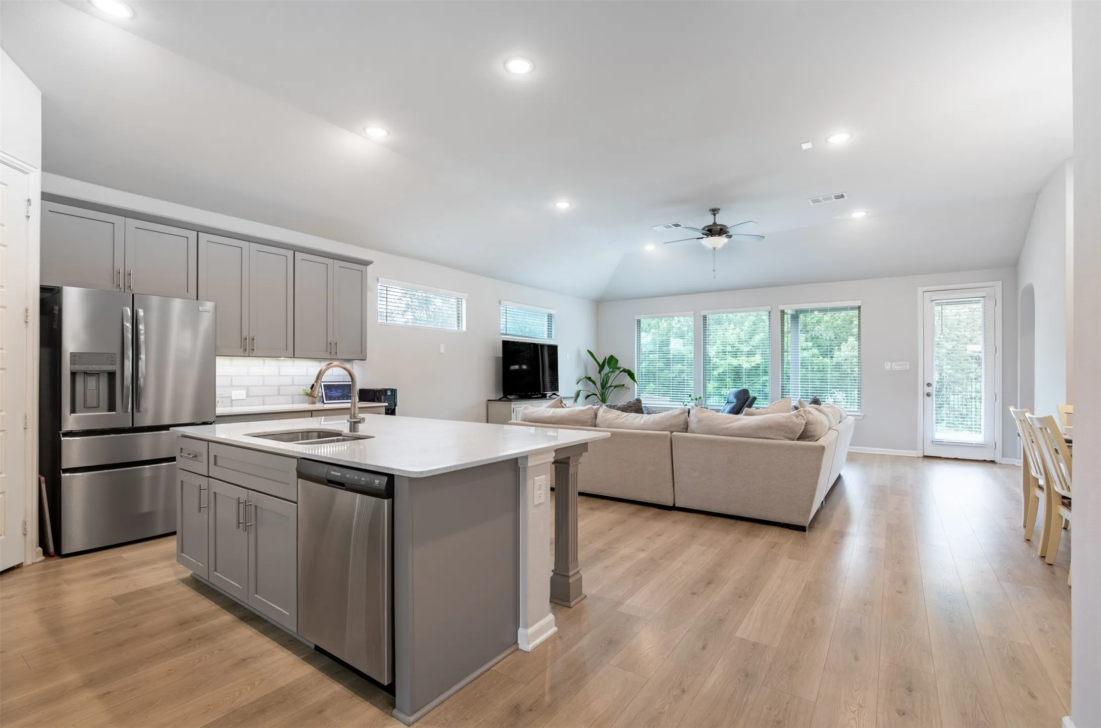 Kitchen flows seamlessly to living room.