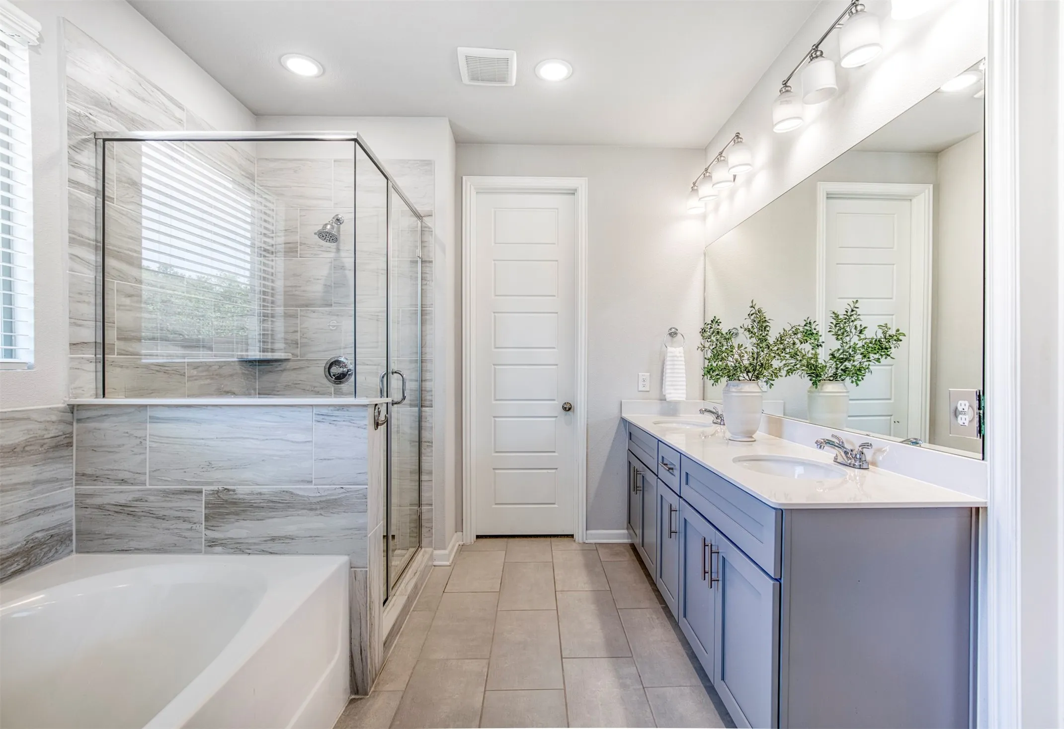Luxury en-suite bath with dual sinks.
