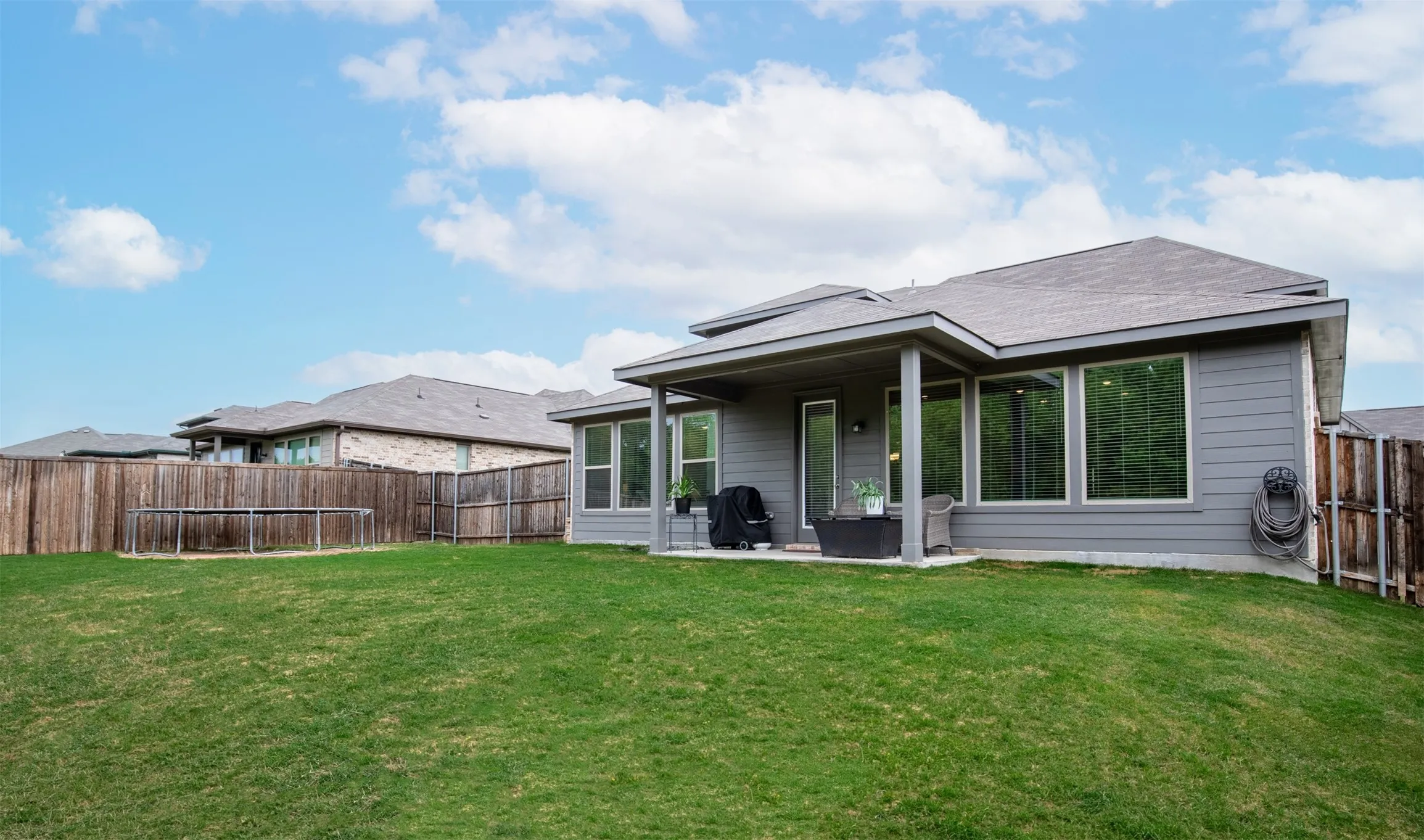 Large grassy backyard. Great for family activities.