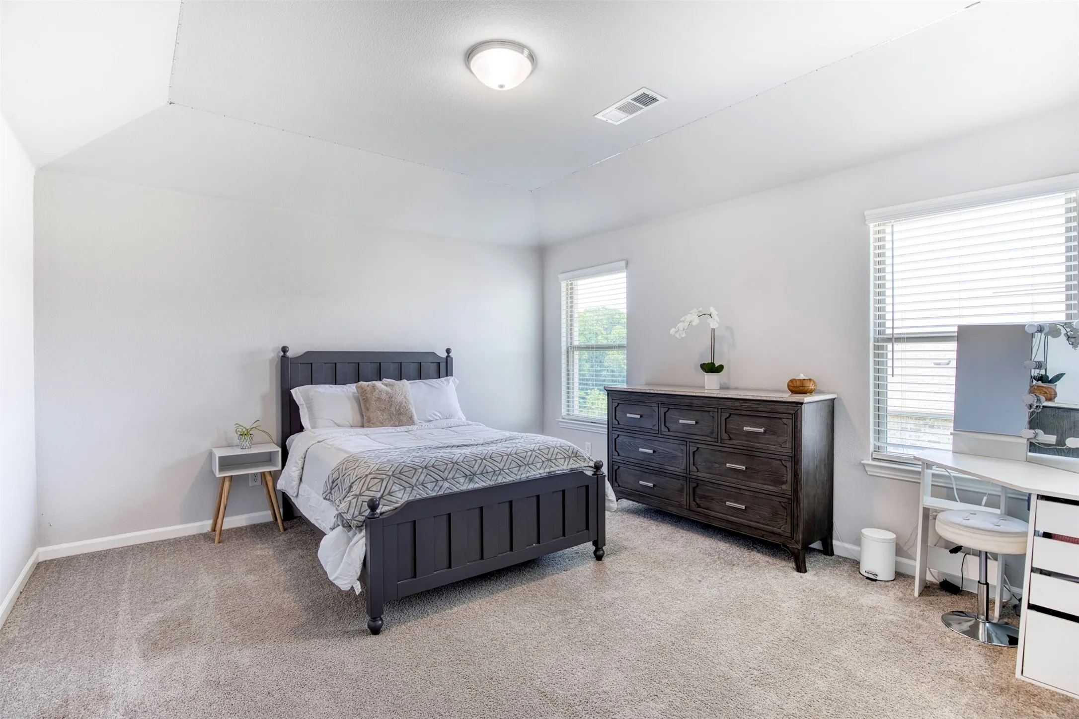 Secondary bedroom with sloped ceiling.