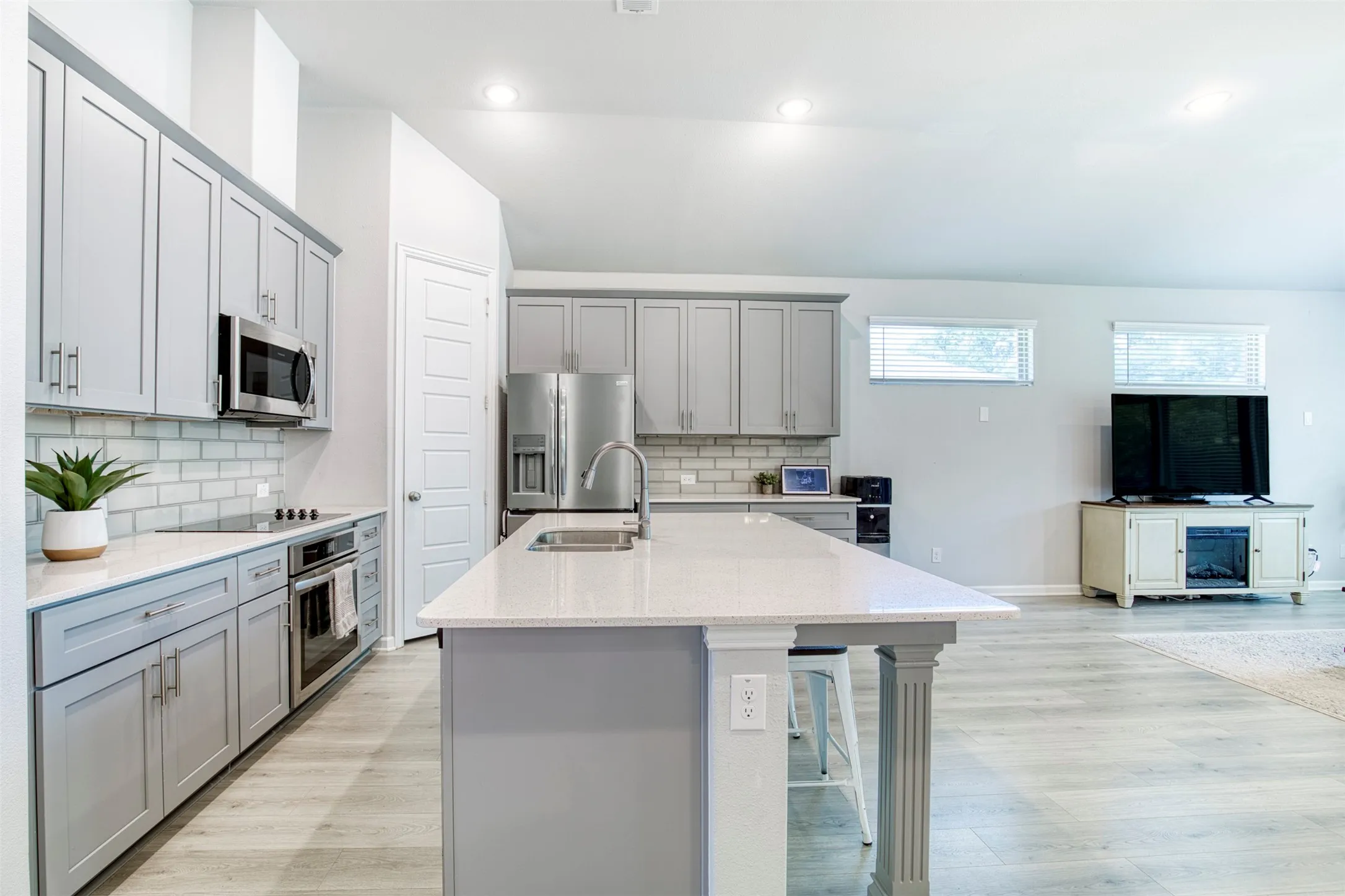 Kitchen features luxury hardware and stainless steel appliances.