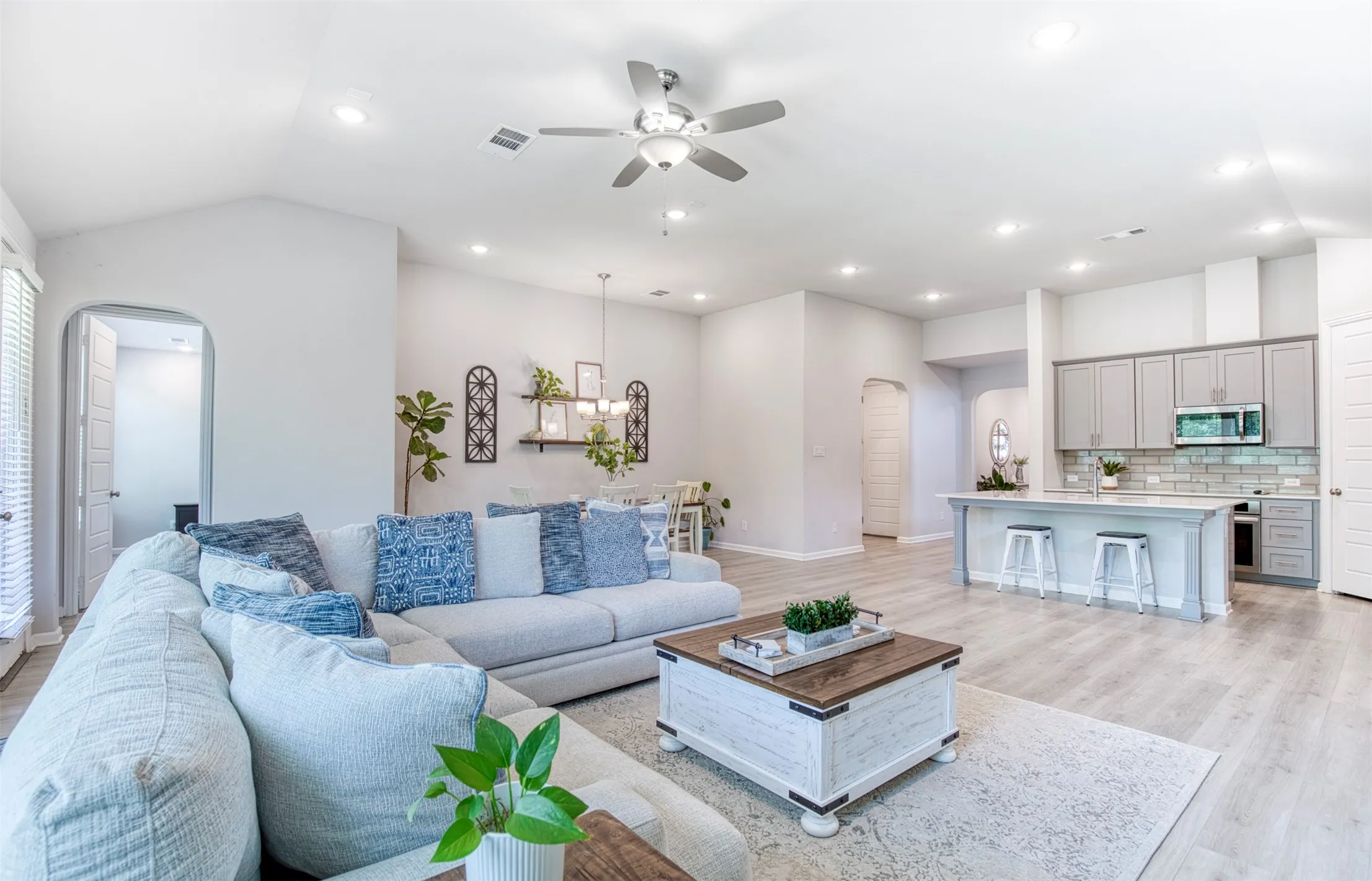 Open concept living room to kitchen and dining.