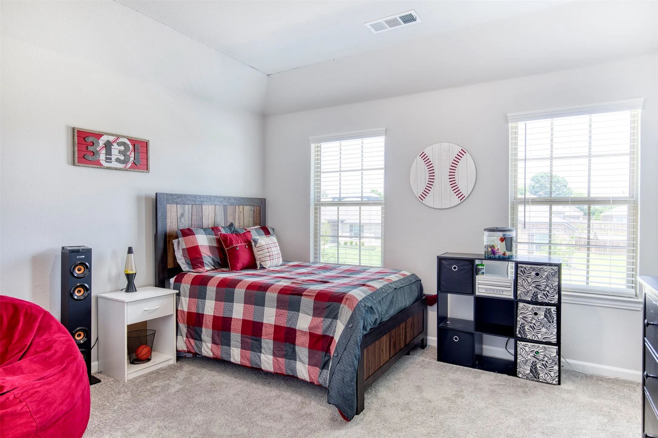 Secondary upstairs bedroom with natural light.