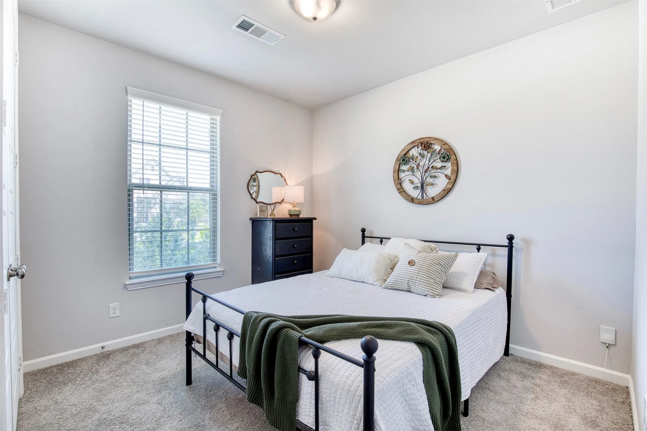 Secondary downstairs bedroom overlooking the front of the home.