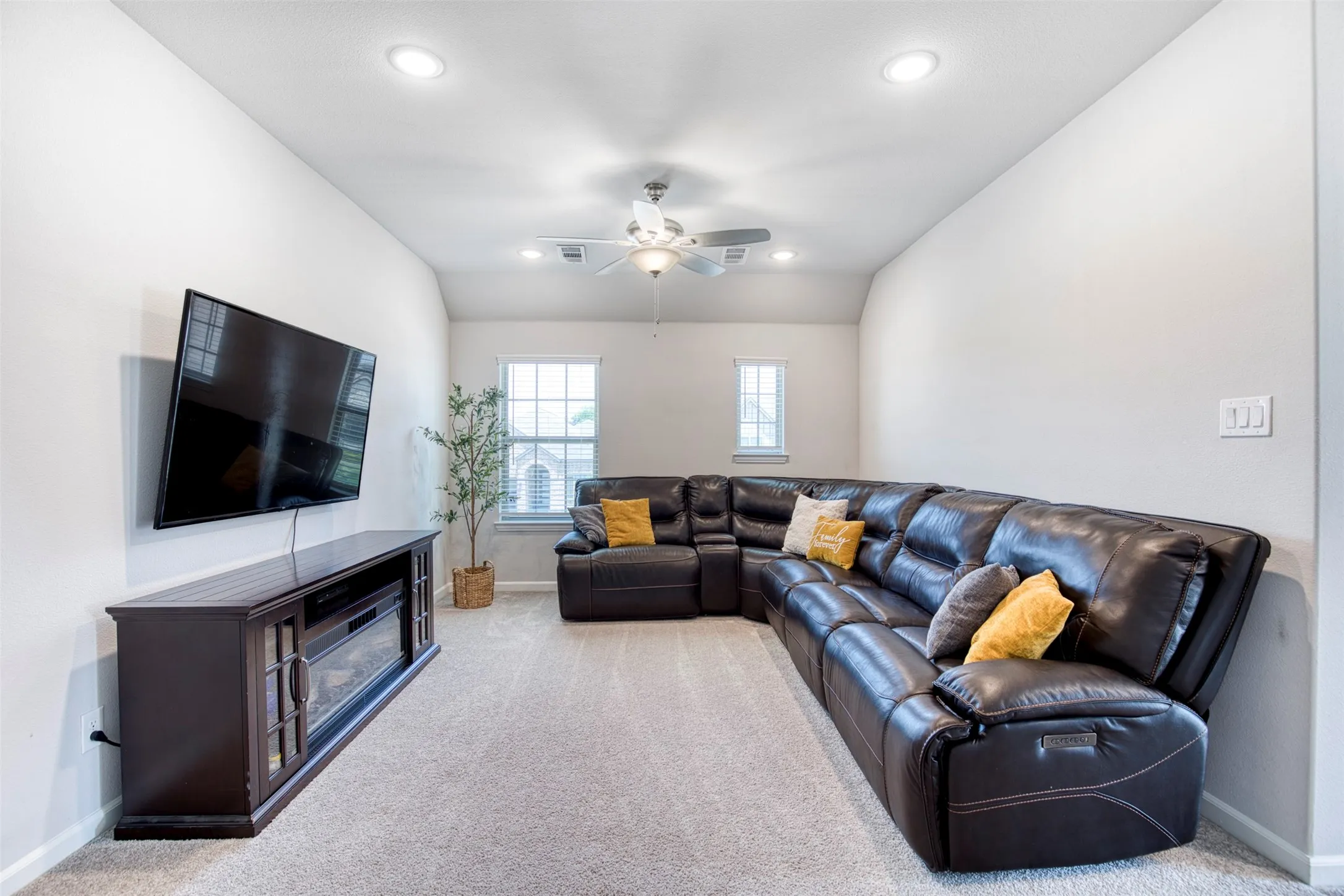 Upstairs game room with recessed lighting and ceiling fan.