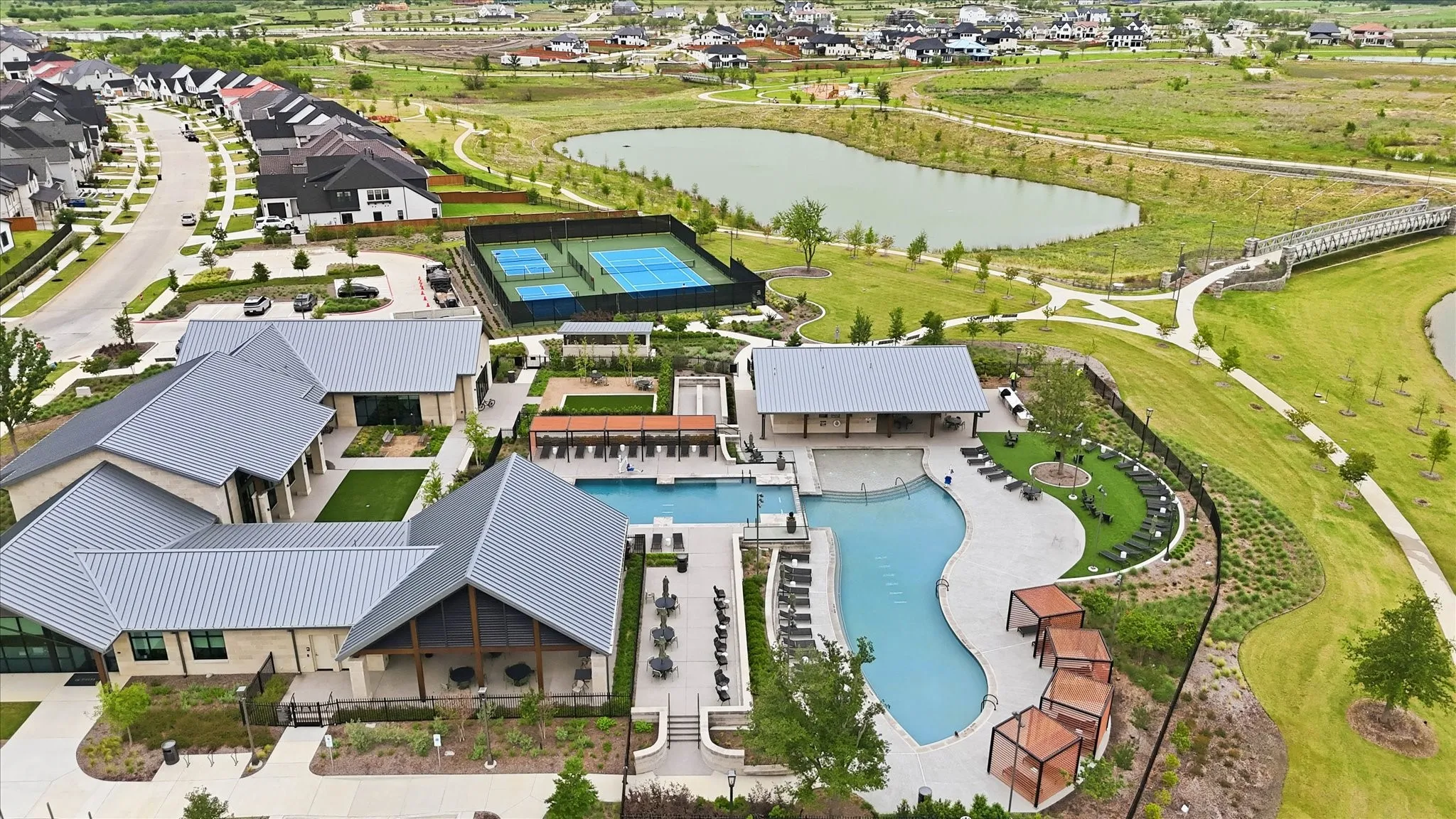 The property is situated in a community featuring a clubhouse with a swimming pool, tennis courts, and a walking path alongside a body of water