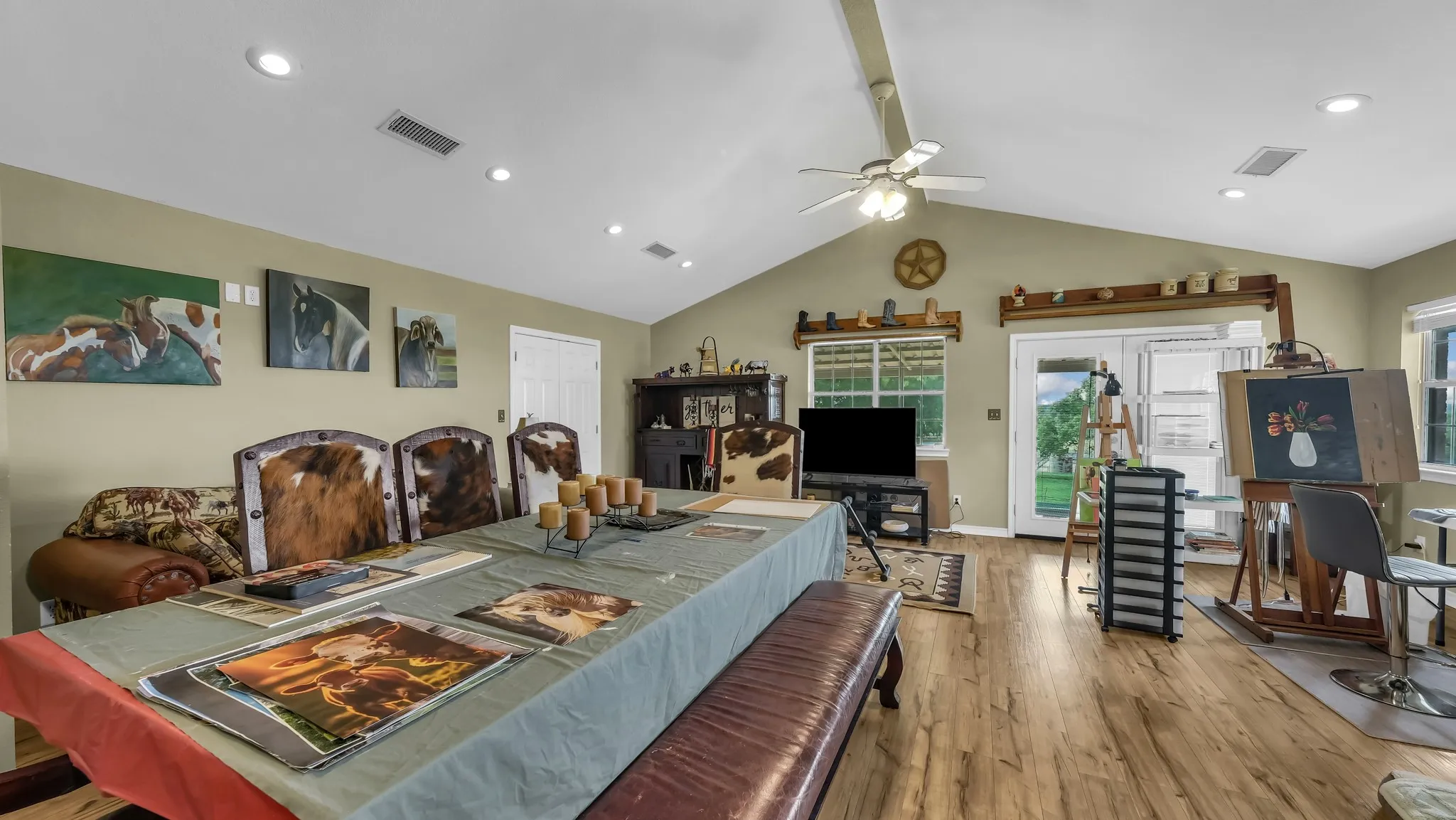 Expansive room featuring vaulted ceilings, recessed lighting, and wood-style flooring