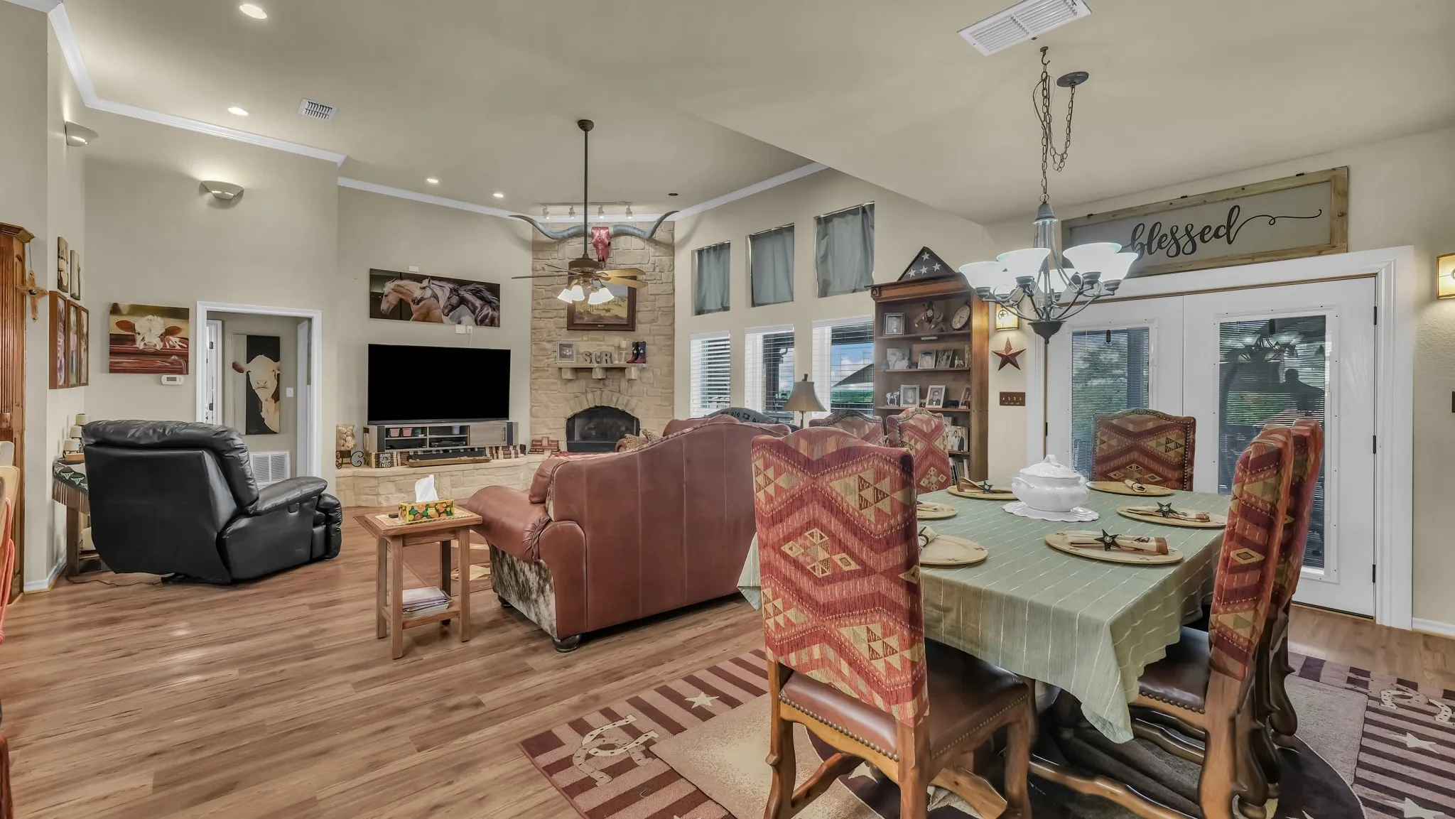 The property features an open living and dining area with wood flooring and a vaulted ceiling