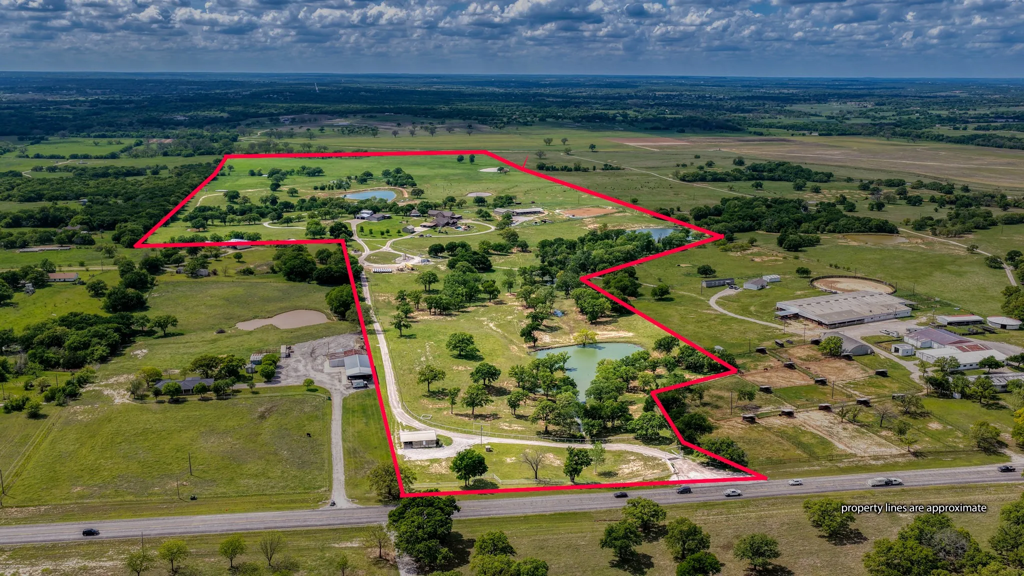 Expansive property featuring verdant landscapes, natural ponds, and mature trees