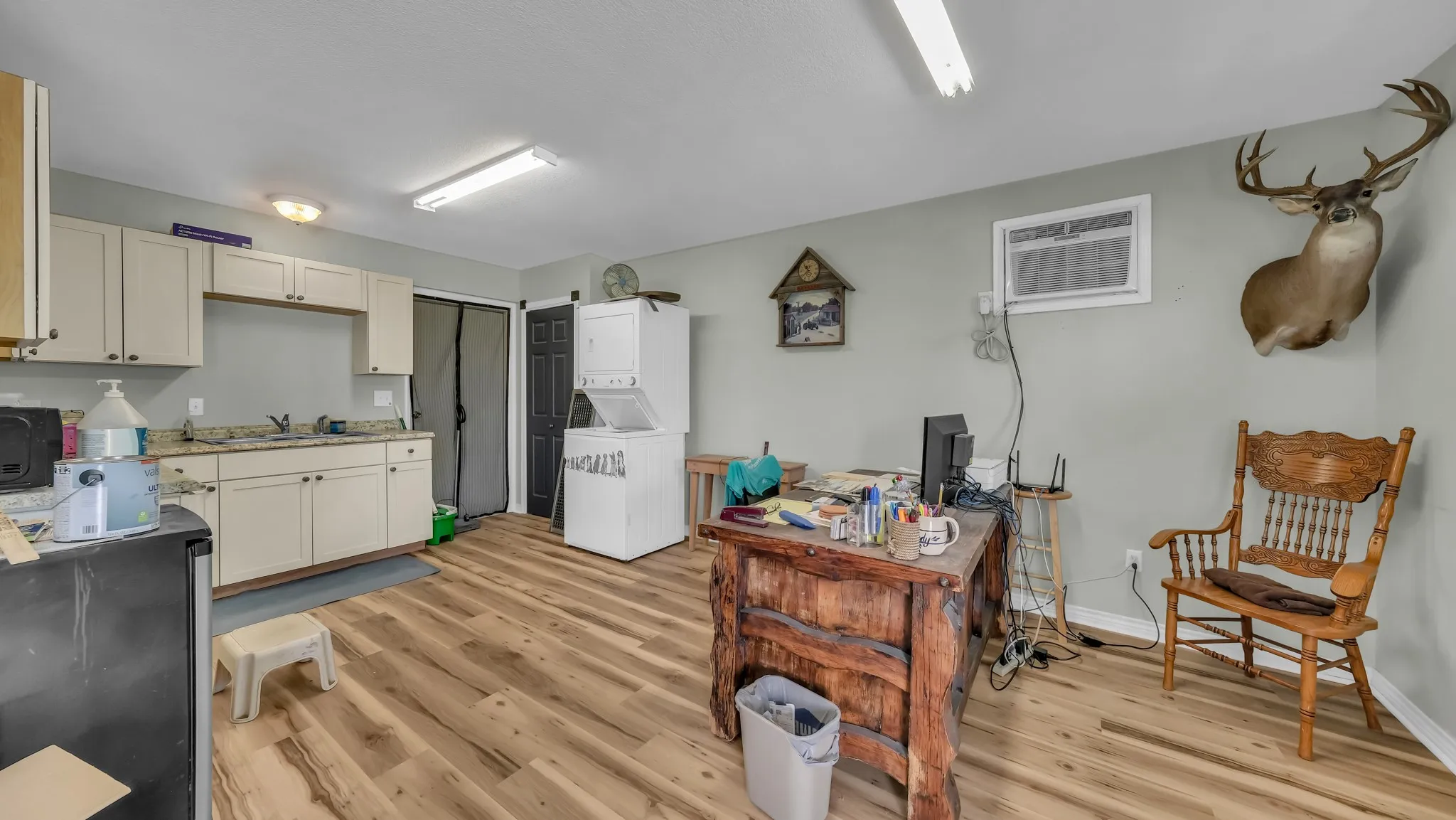 The property features a functional kitchen area with upper and lower cabinetry, a sink, and countertops