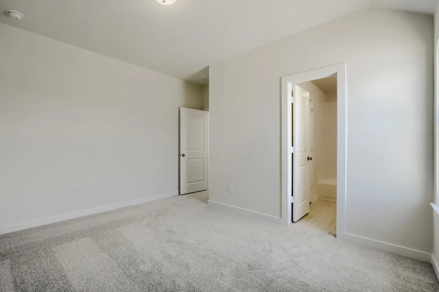 Neutral carpet flooring and light-toned walls