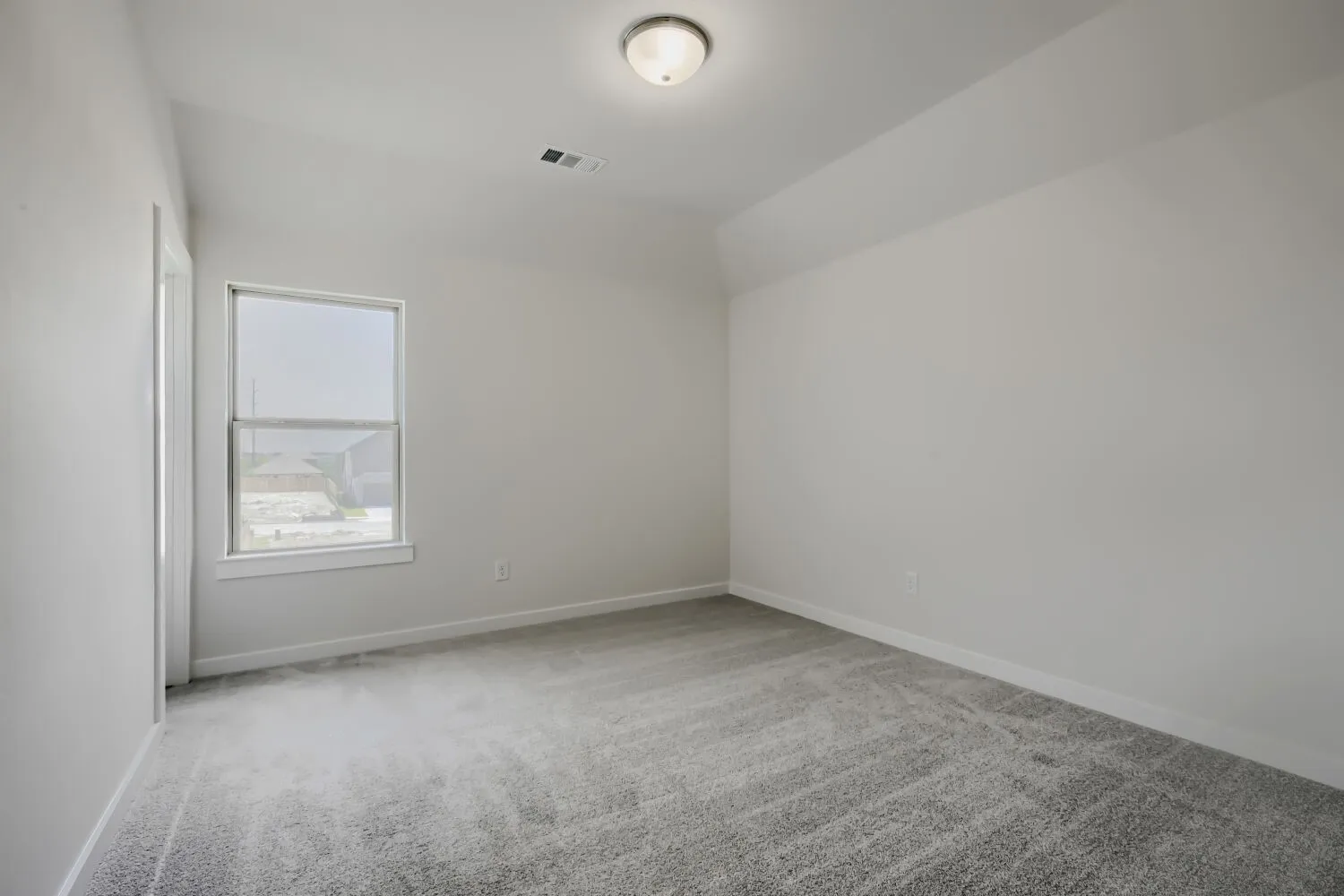 Room featuring light gray carpet flooring, white painted walls, and a single window with white trim