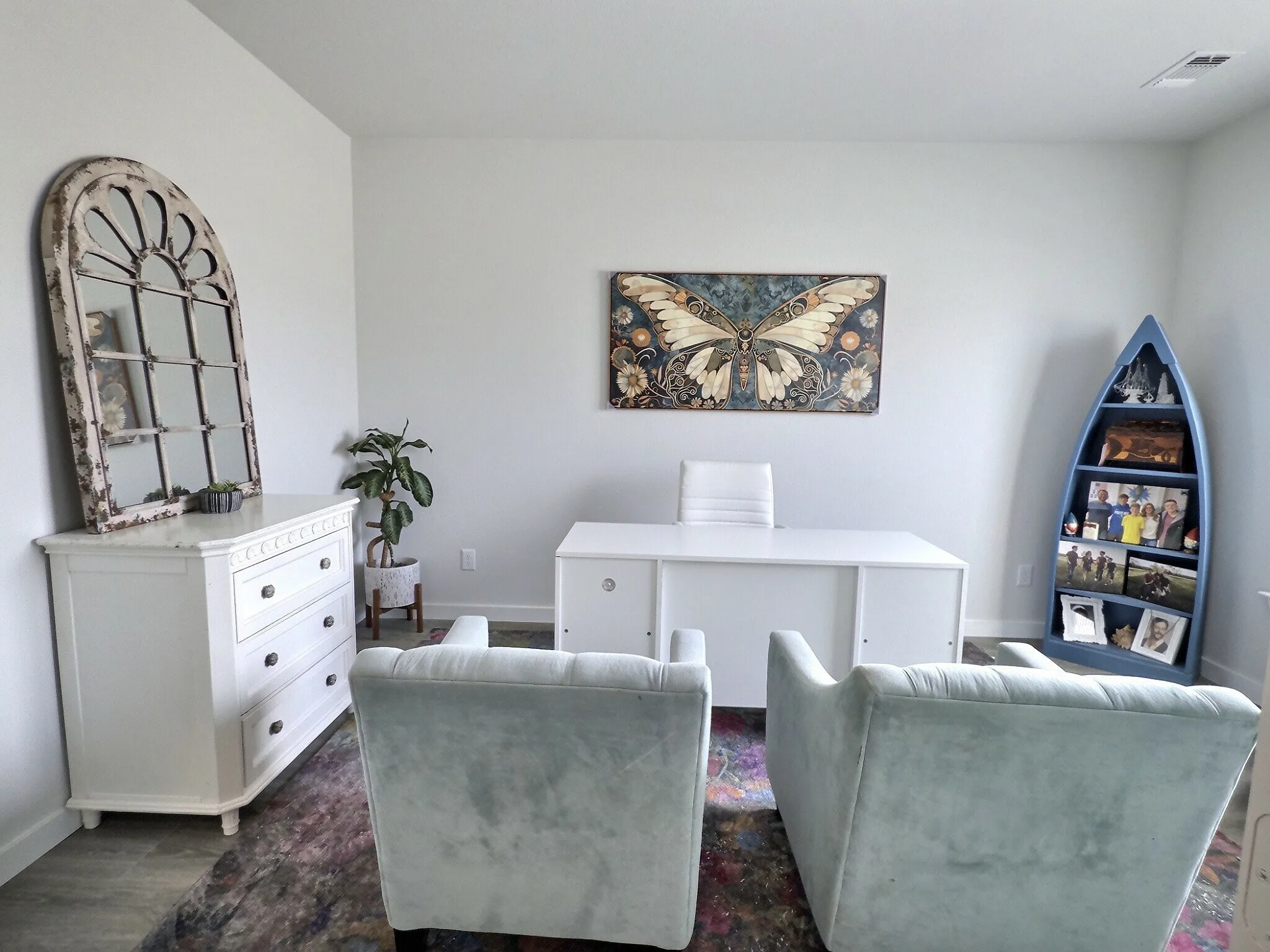 This room features light-colored walls and a desk, providing a functional workspace