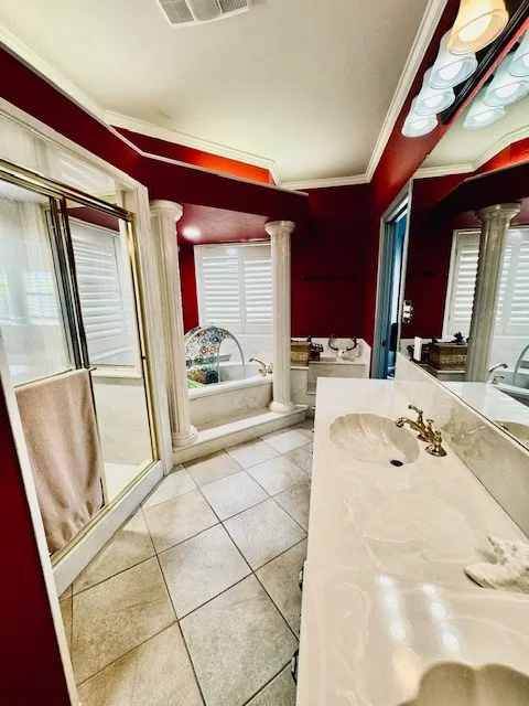 Bathroom featuring ornate columns, vanity, ornamental molding, tile patterned flooring, and visible vents