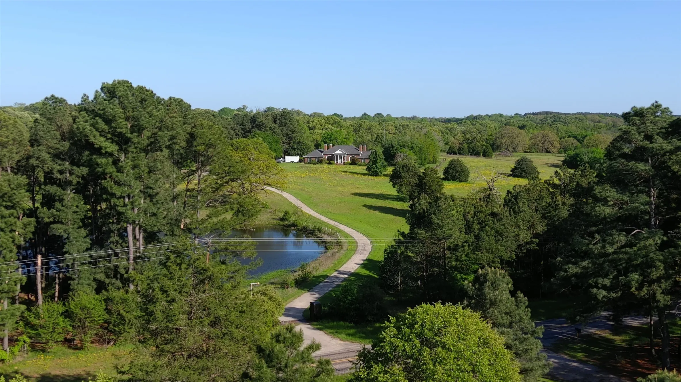 Birds eye view of property featuring a wooded view and a water view