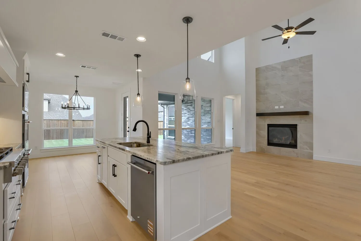 Gourmet kitchen island with an undermount sink and pendant lighting