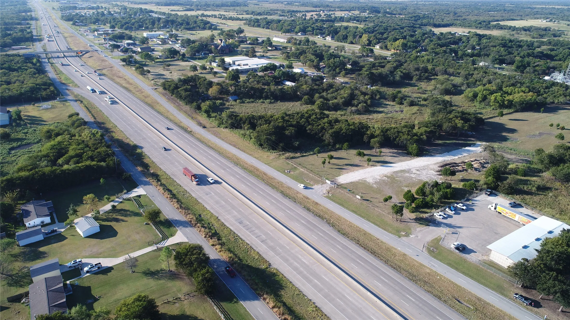 Aerial view showcasing the expansive highway and surrounding green landscape