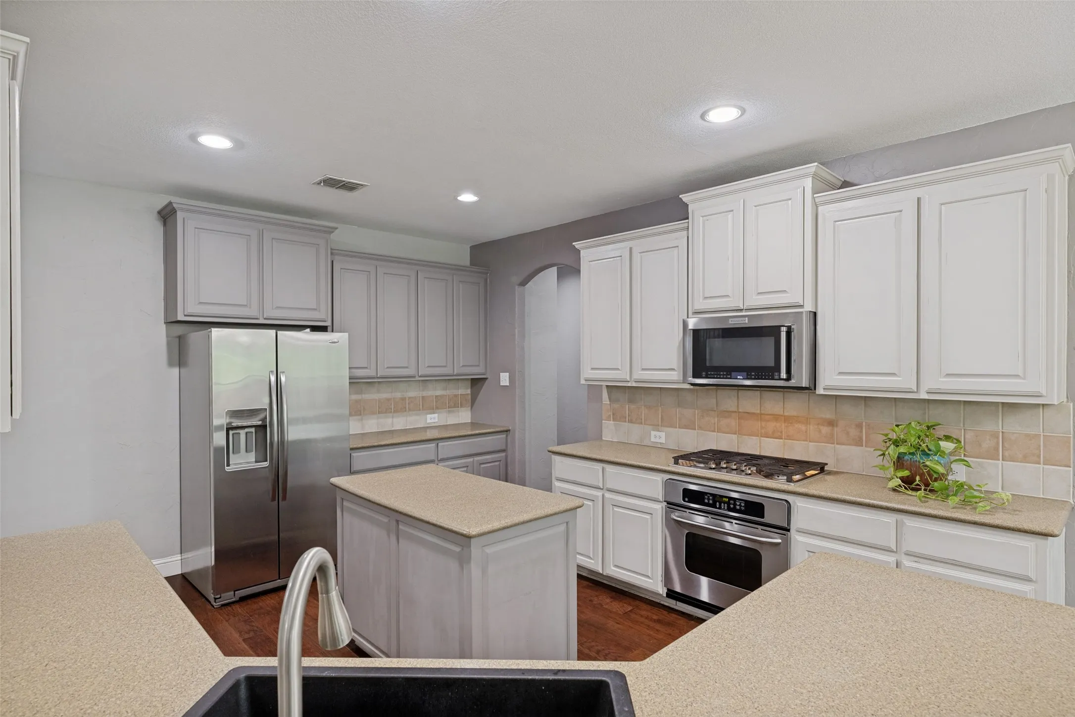 The kitchen is outfitted with stainless-steel appliances, and new sink.