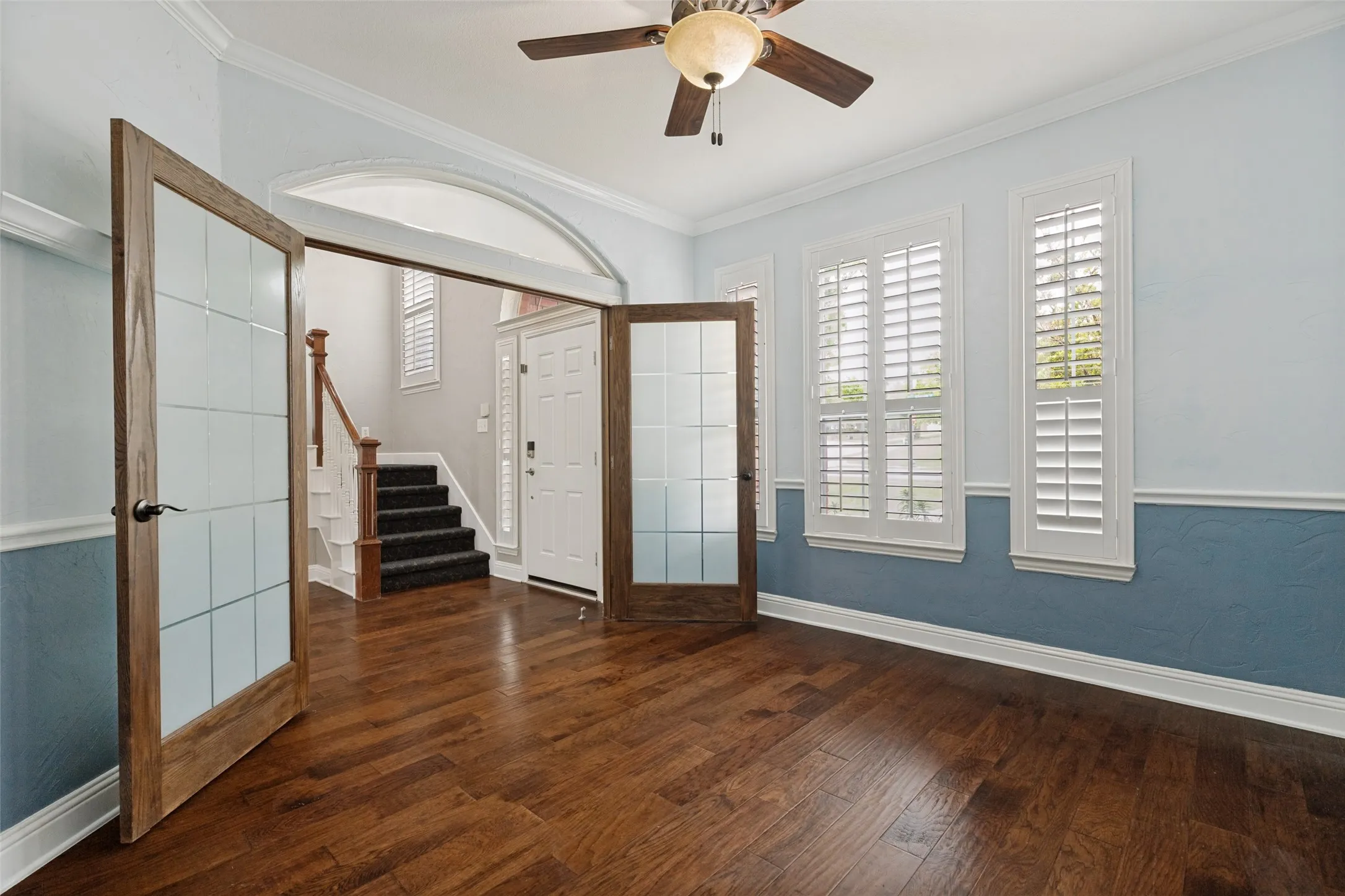Beautiful glass front French doors adorn the office.
