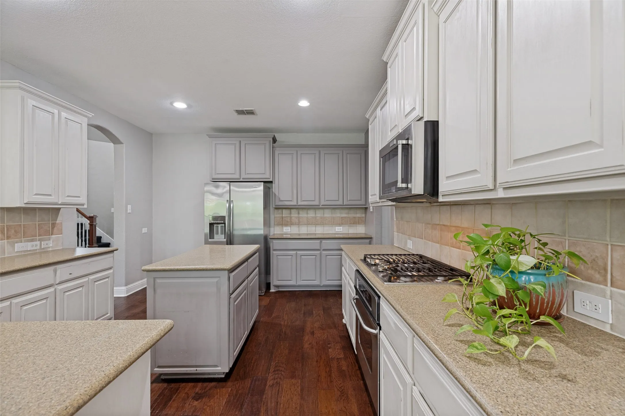 Cabinetry updated in a grey and white palette.