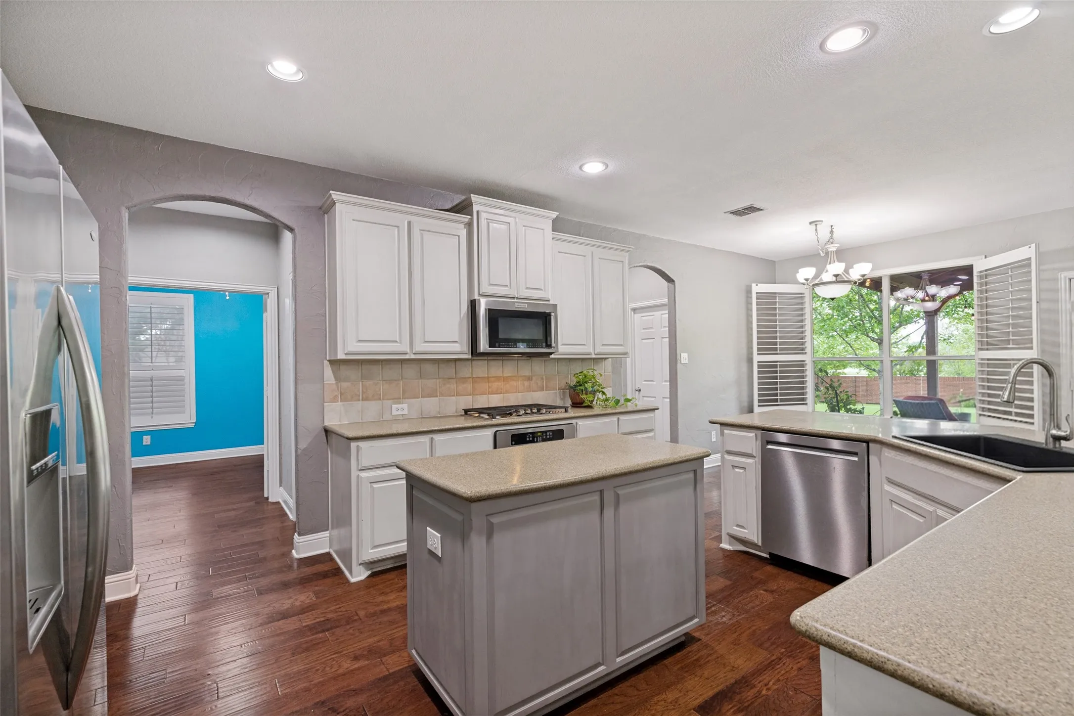 Island kitchen boasts loads of counter and cabinet space.