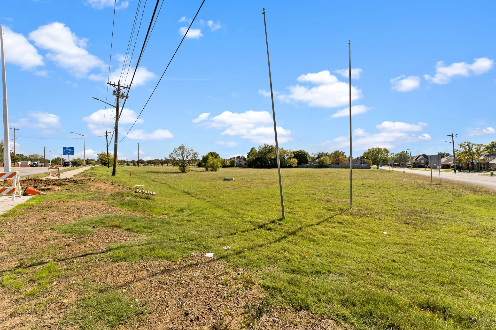 Expansive grassy lot with clear blue skies, offering a substantial land area