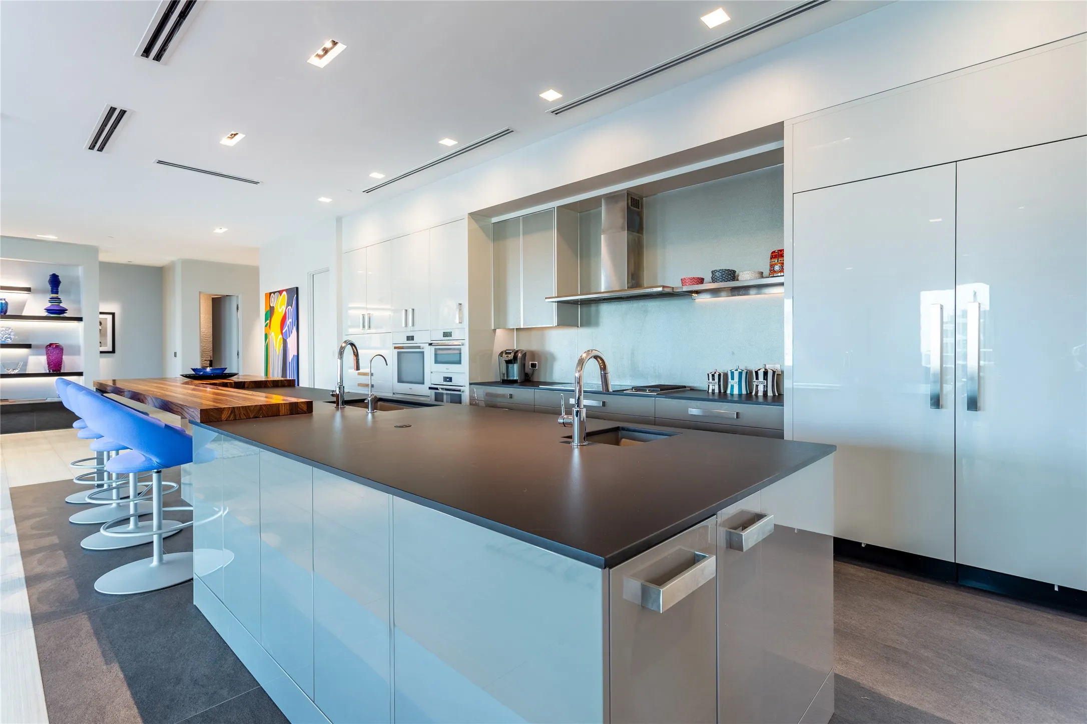 Black Silestone counters, white & gray gloss cabinetry