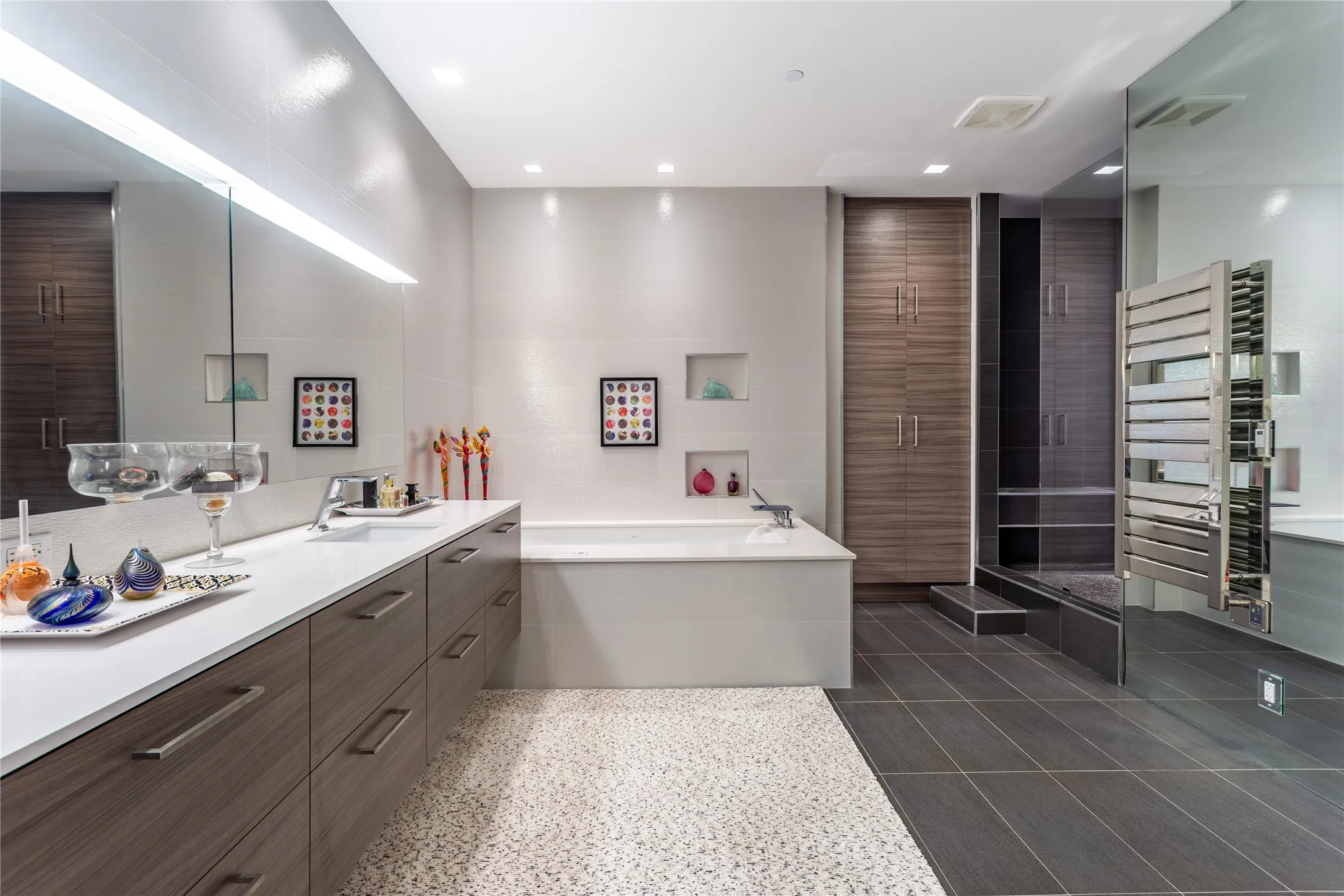 Huge Primary Bath has floating vanity, lighted mirrors, jetted tub.
