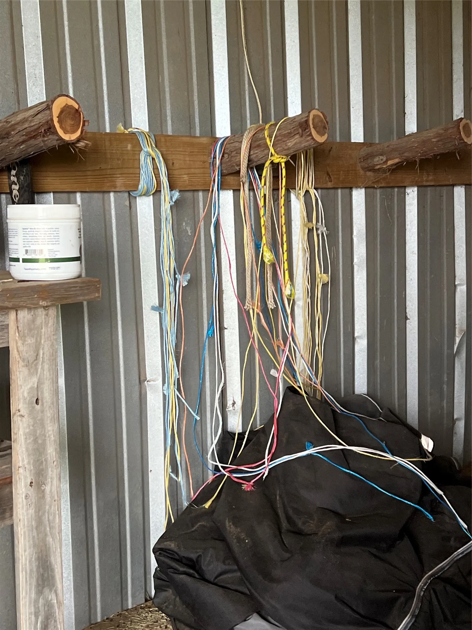 The property features corrugated metal siding and a wooden storage rack