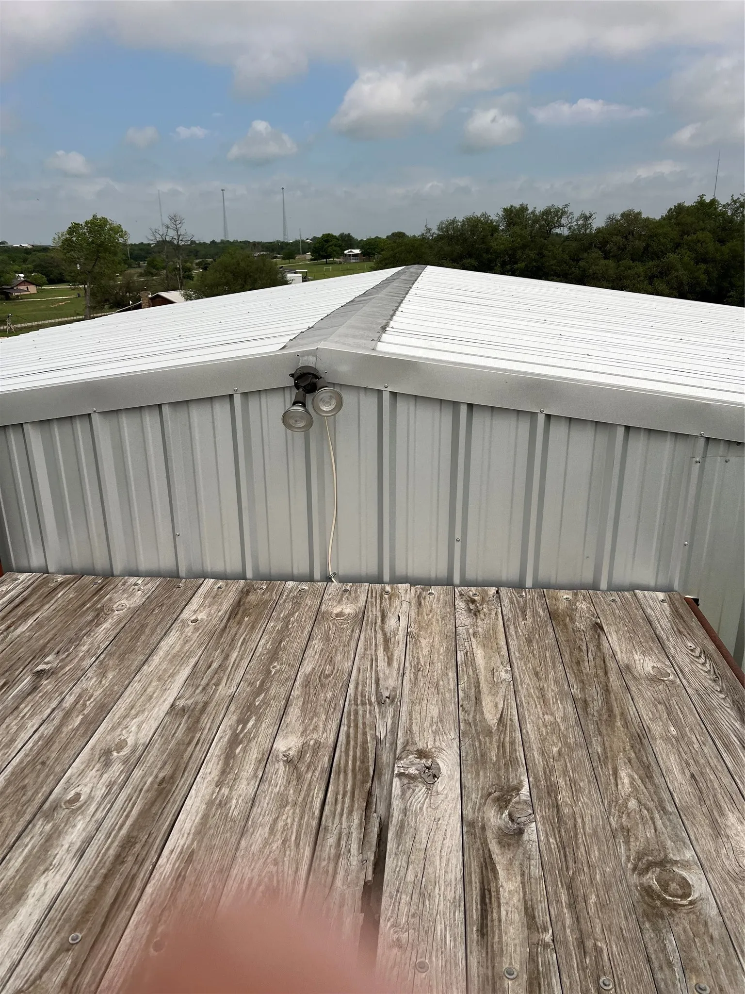 The property features a metal roof and a wooden deck