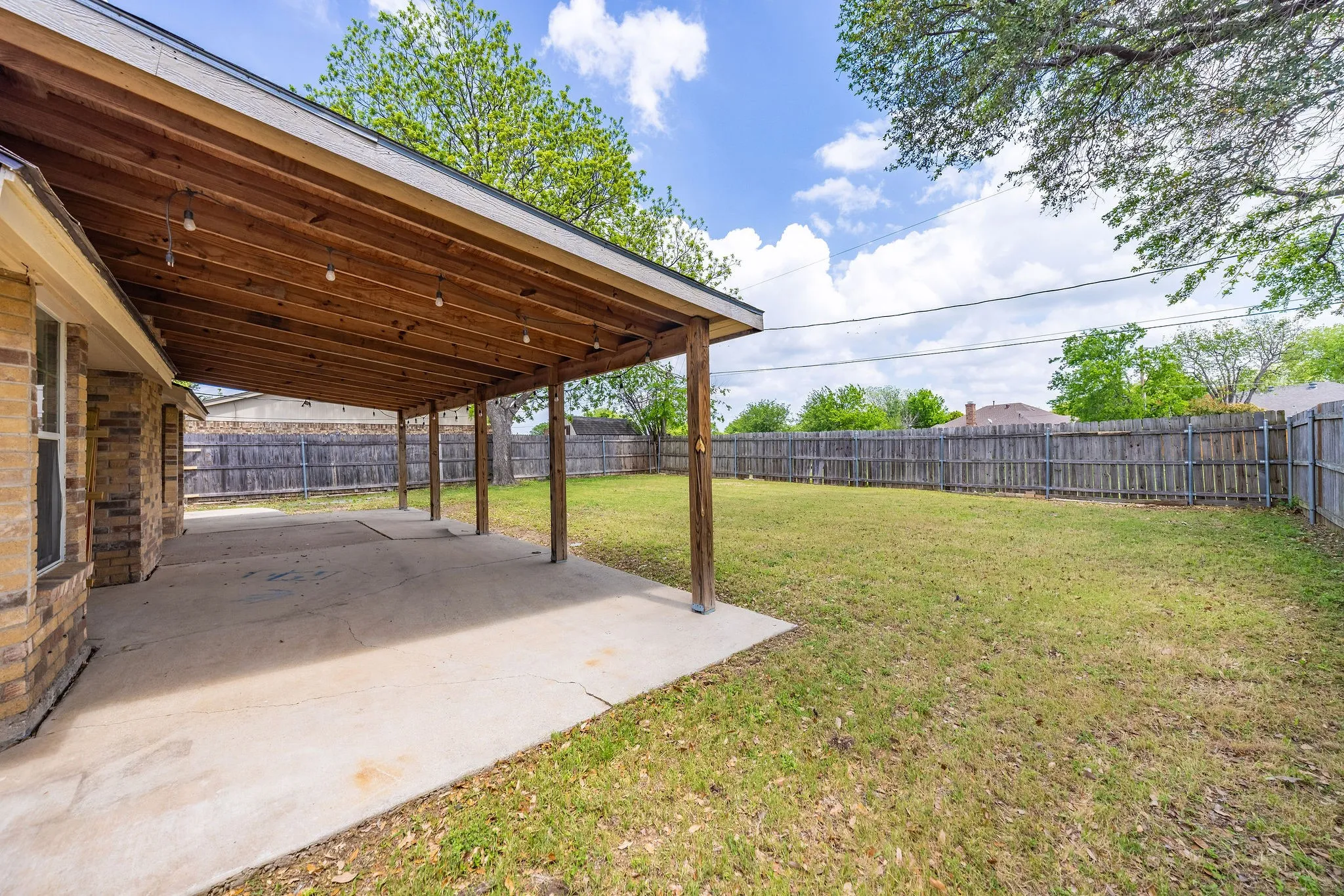 Spacious covered patio with a yard big enough for a pool!