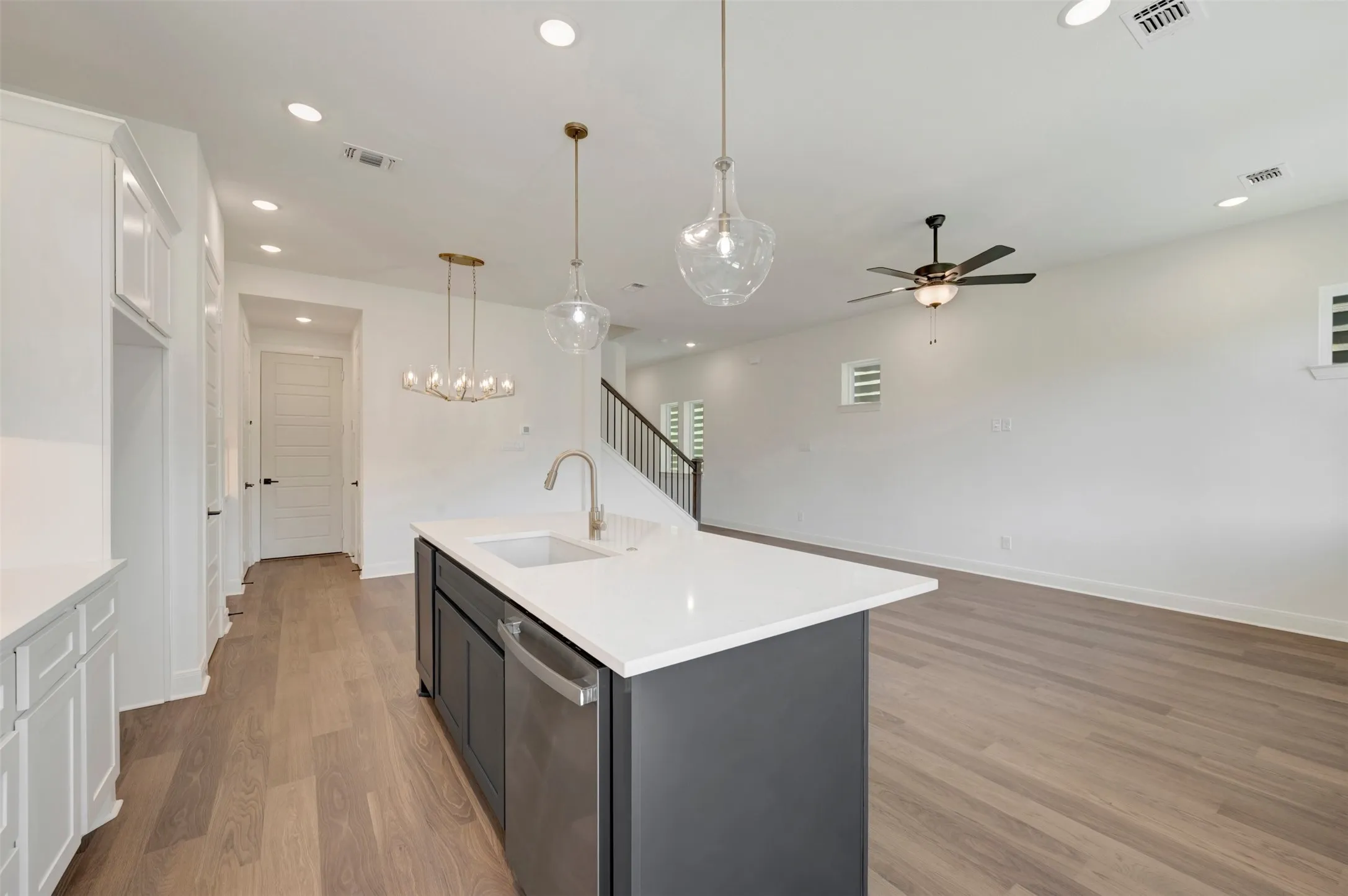 Kitchen island featuring a white countertop and integrated sink