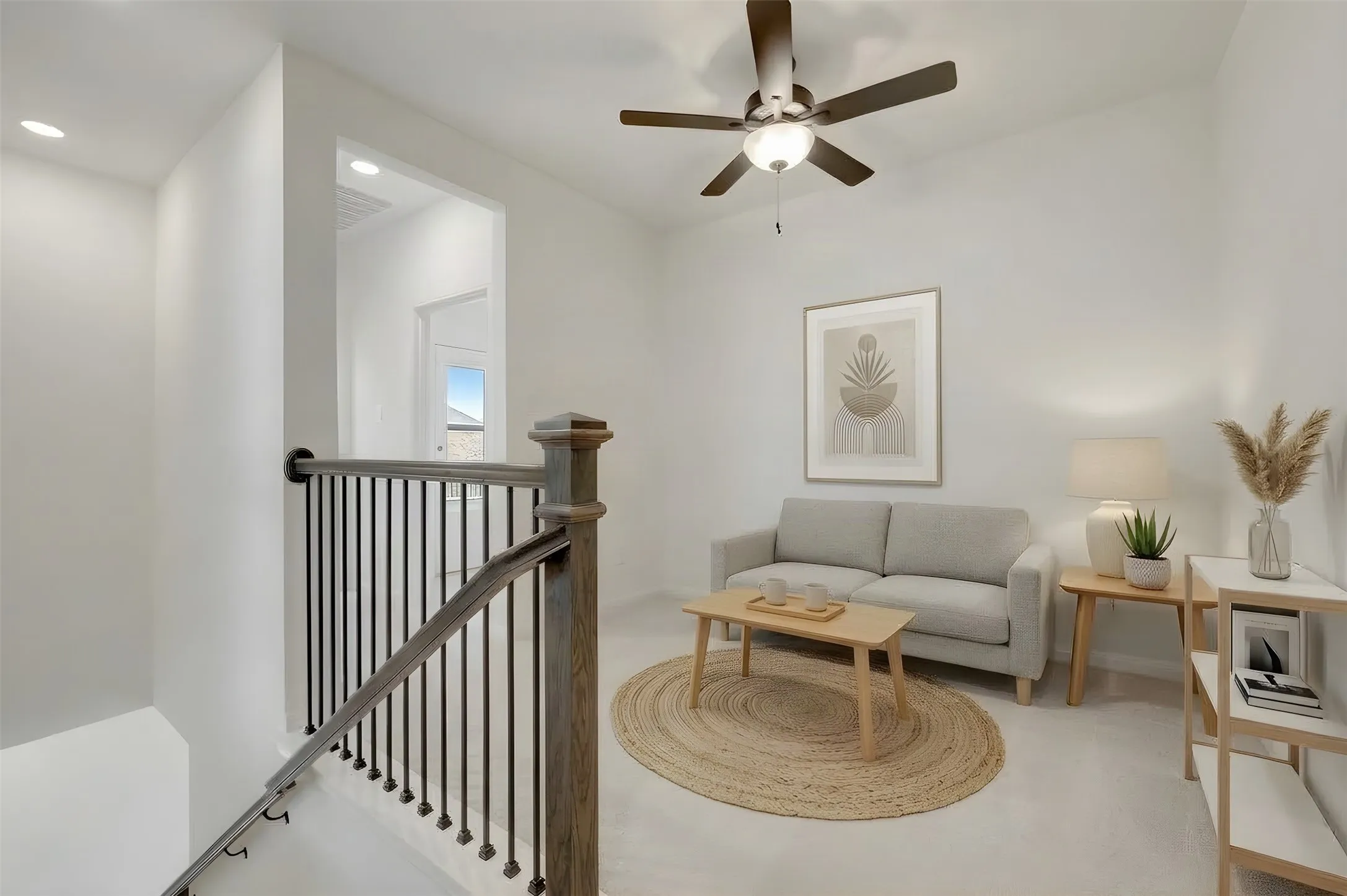 Staircase with wood-finish handrail and black metal balusters