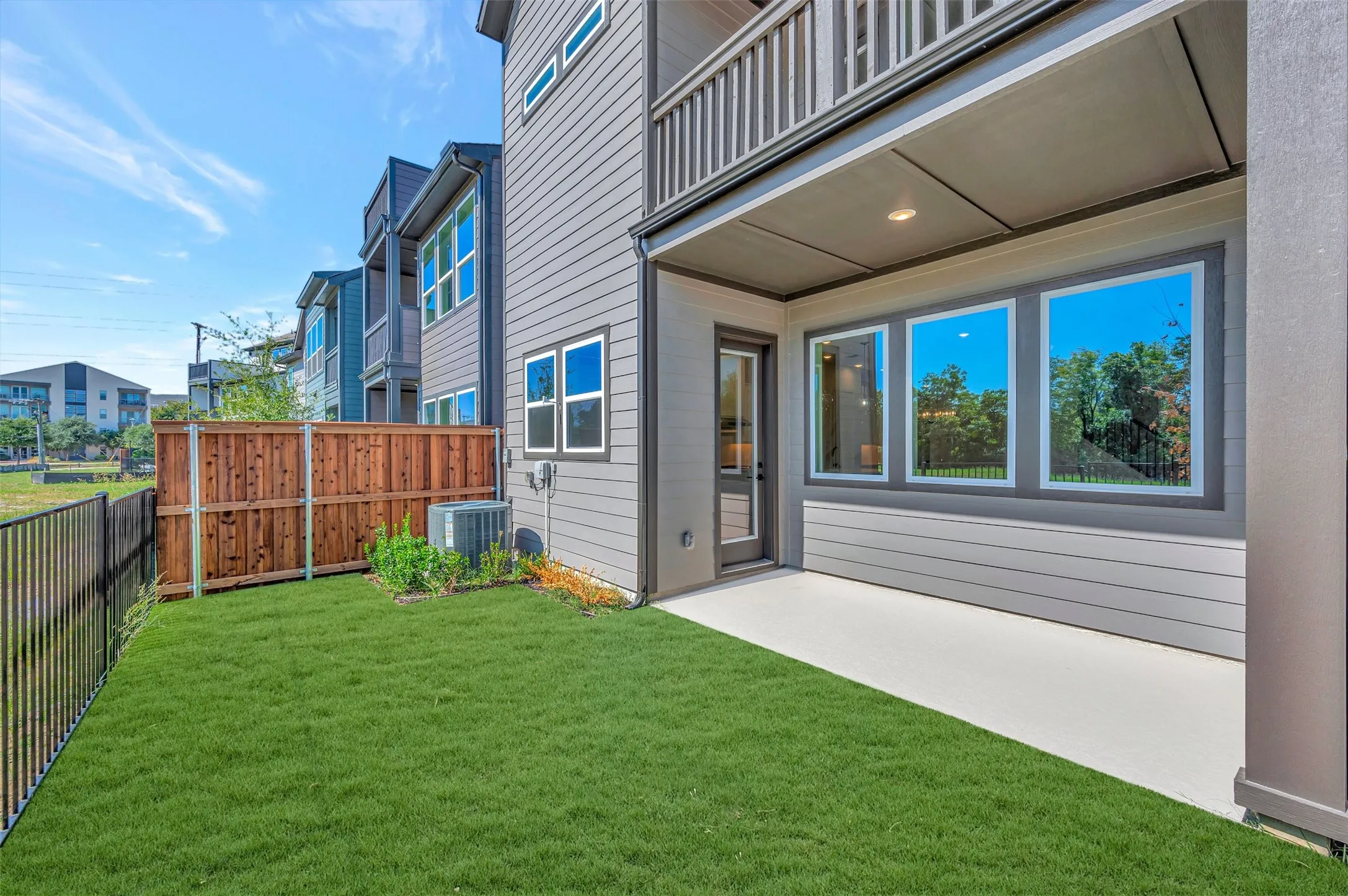 Expansive concrete patio with a covered outdoor area