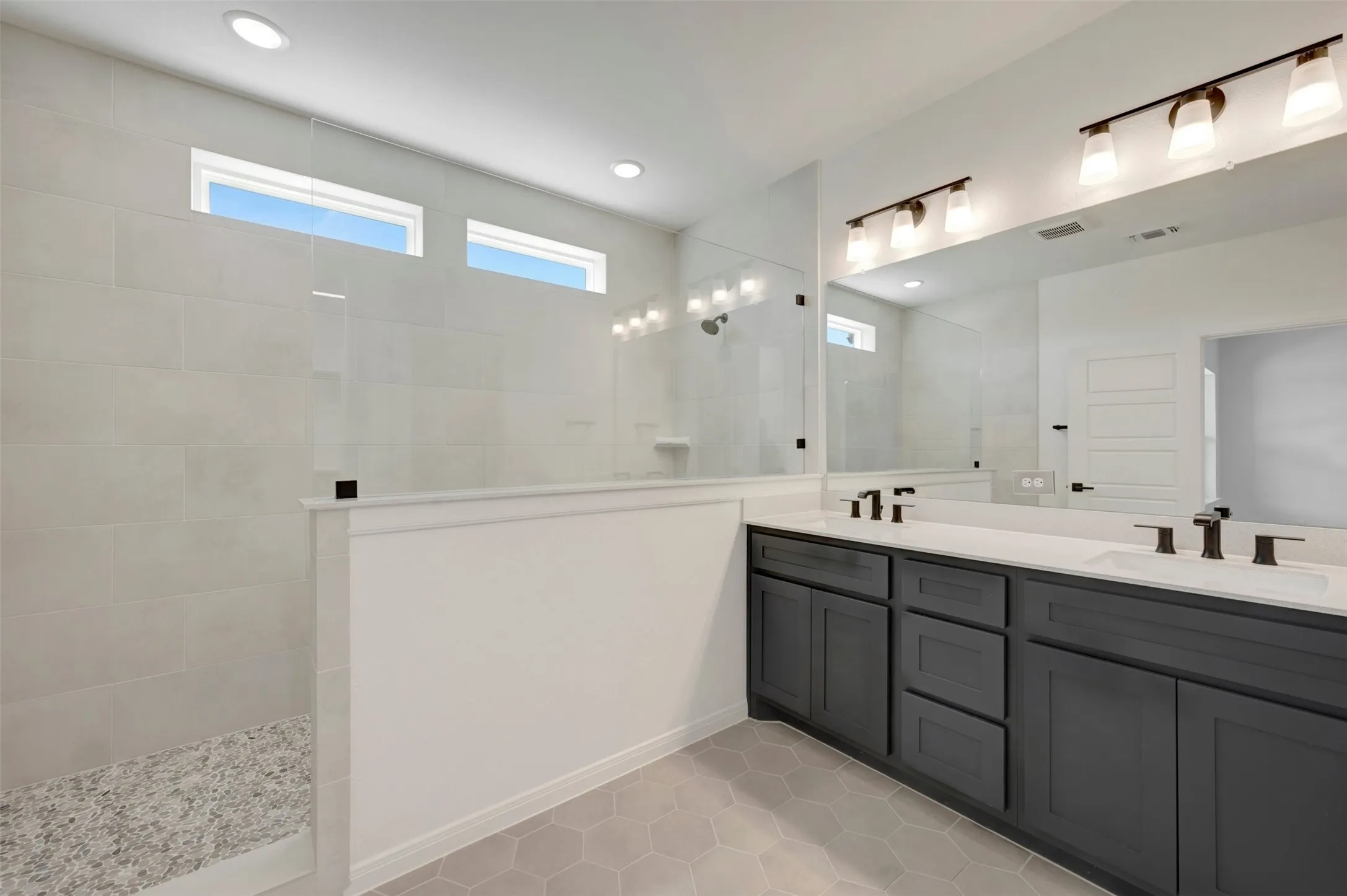 Double vanity with dark wood-finish cabinetry, white countertop, and matte black fixtures